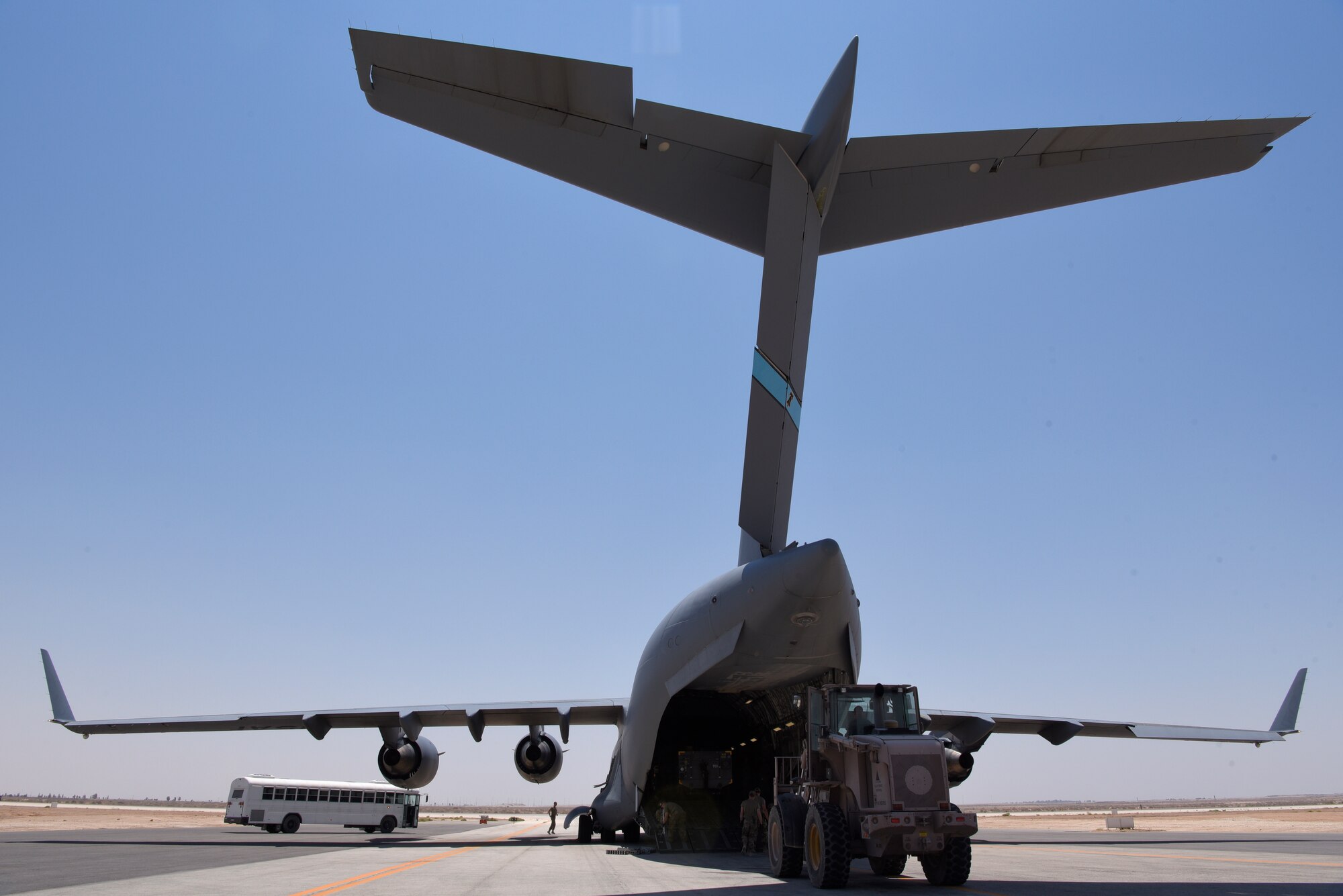 Airmen transport gear off of a C-17