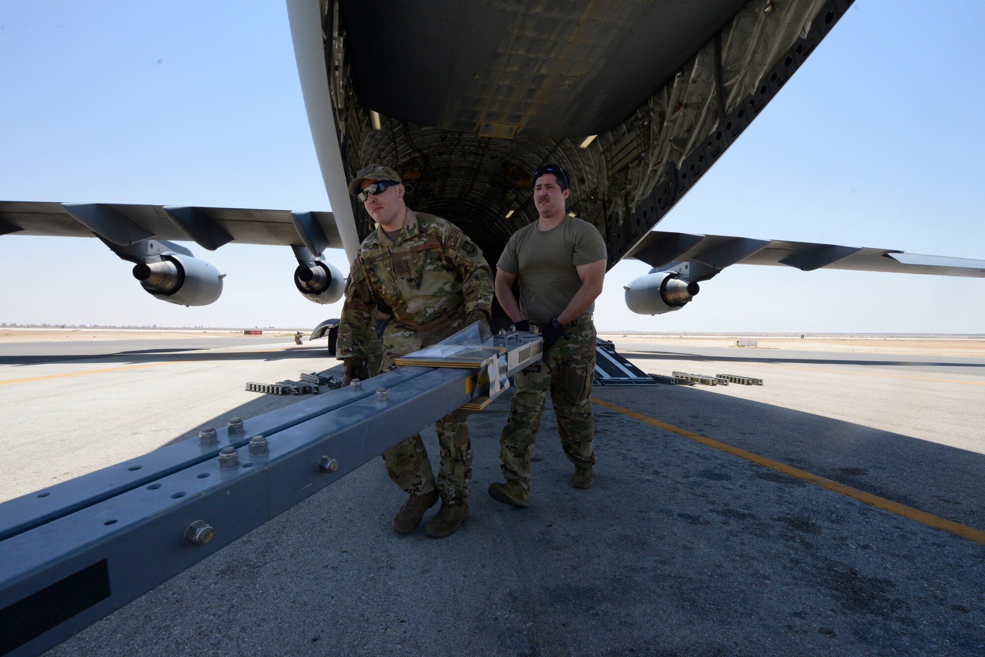 Airmen transporting gear.