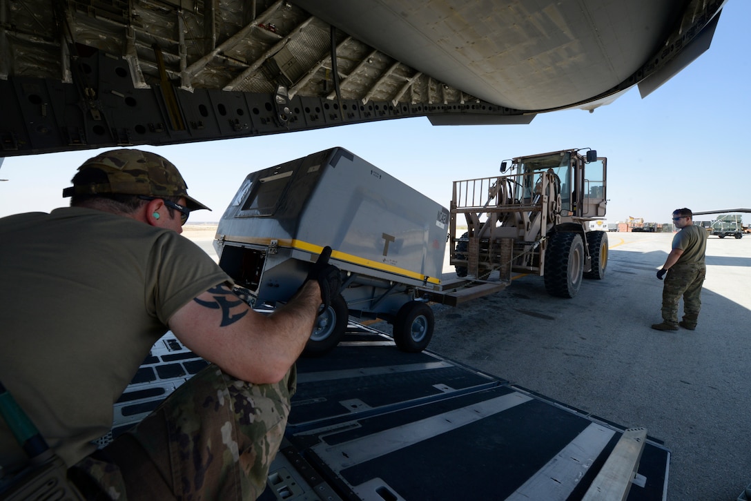 Airmen transporting gear.