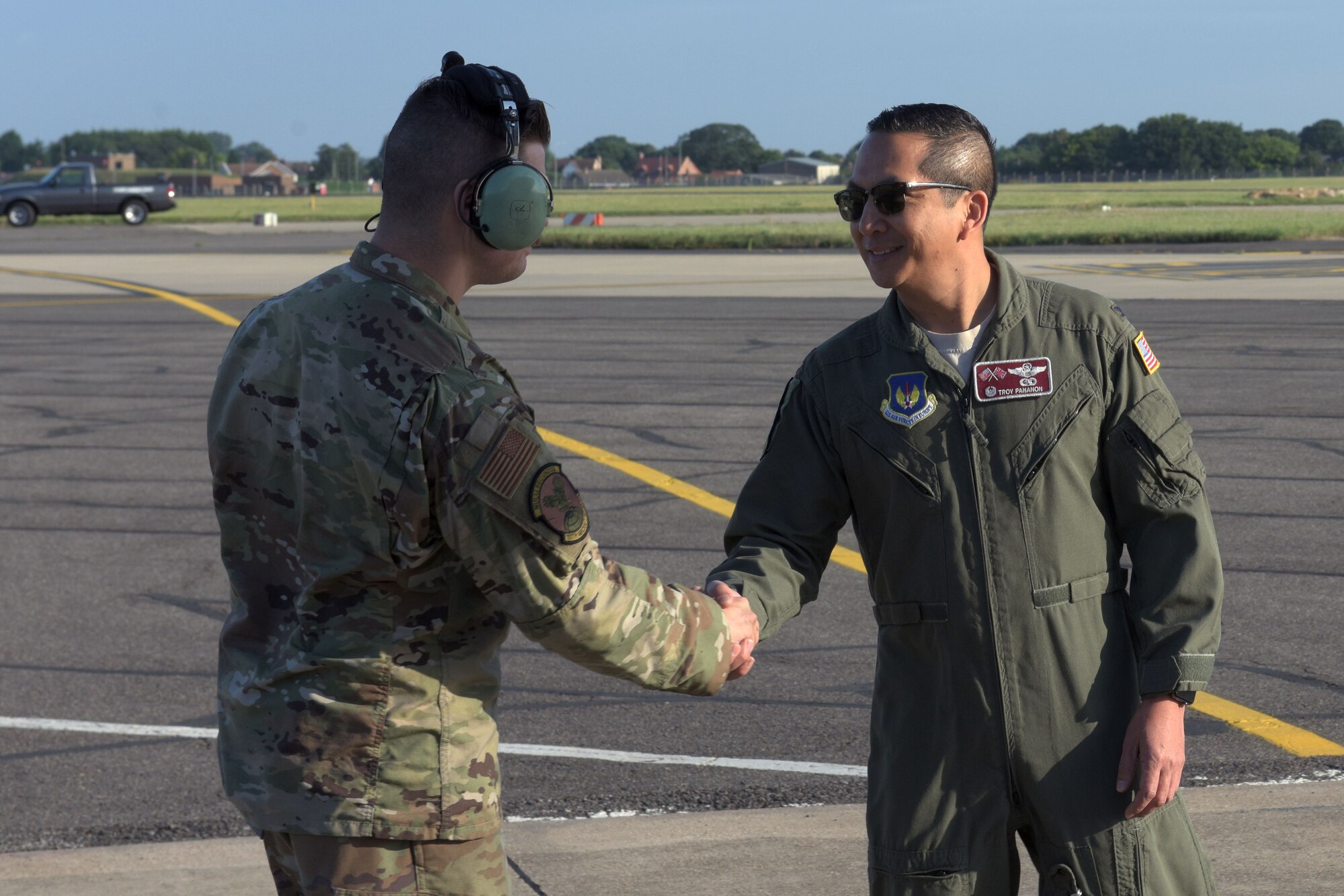 Col. Troy Pananon, 100th Air Refueling Wing commander, shakes hands with Senior Airman Alfonso Hernandez, 100th Aircraft Maintenance Squadron crew chief, at RAF Mildenhall, England Aug. 6, 2019. Pananon and Hernandez performed a walkaround inspection of the KC-135 Stratotanker prior to departure to Spain. (U.S. Air Force photo by Senior Airman Benjamin Cooper)