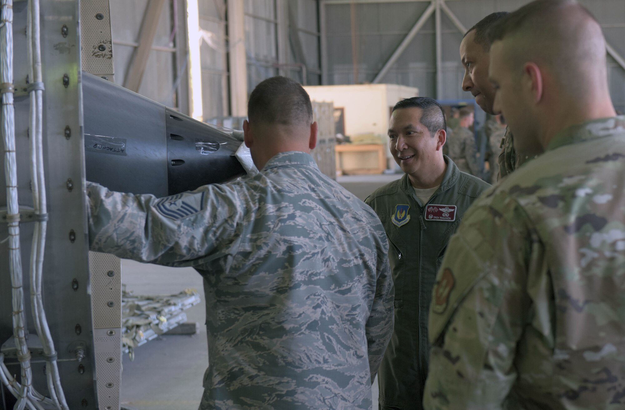 Col. Troy Pananon, 100th Air Refueling Wing commander, speaks with deployed Airmen attached to the 351st Expeditionary Air Refueling Squadron, at Moron Air Base, Spain, Aug. 6, 2019. The Airmen were explaining the condition of a KC-135 Stratotanker engine under repair. (U.S. Air Force photo by Senior Airman Benjamin Cooper)