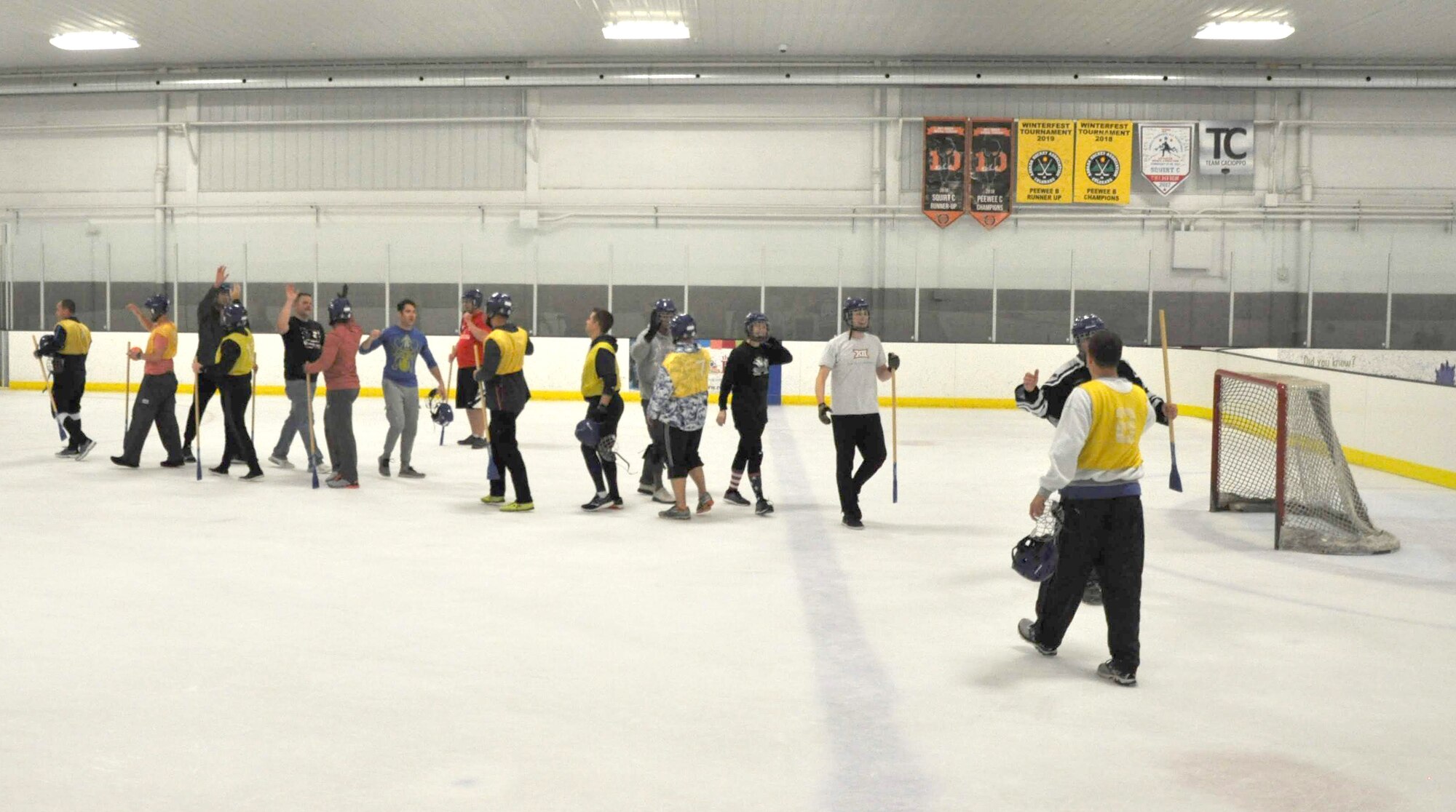Members of the 38th Reconnaissance Squadron congratulate each other by high-fiving after a game of Broomball June 21, 2019, at Grover Ice Rink, Omaha, Nebraska. The squadron participated in this unit cohesion event funded by the Unite Program. The program is the vision of Gen. David L. Goldfein, Air Force chief of staff, who recognized the need to take care of our squadrons by allowing units to focus on resiliency and cohesion for its members.