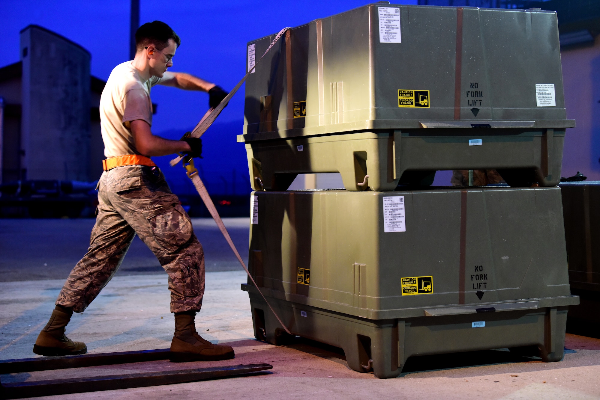 An Airman straps containers together allowing for safe and secure movement of materials during Combat Ammunition Production Exercise 2019 on Aug. 7, 2019, at Aviano Air Base, Italy. Conducting exercises such as CAPEX enables Airmen to learn in a controlled environment, bolstering unit interoperability and refining their practice. (U.S. Air Force photo by Airman 1st Class Caleb House)