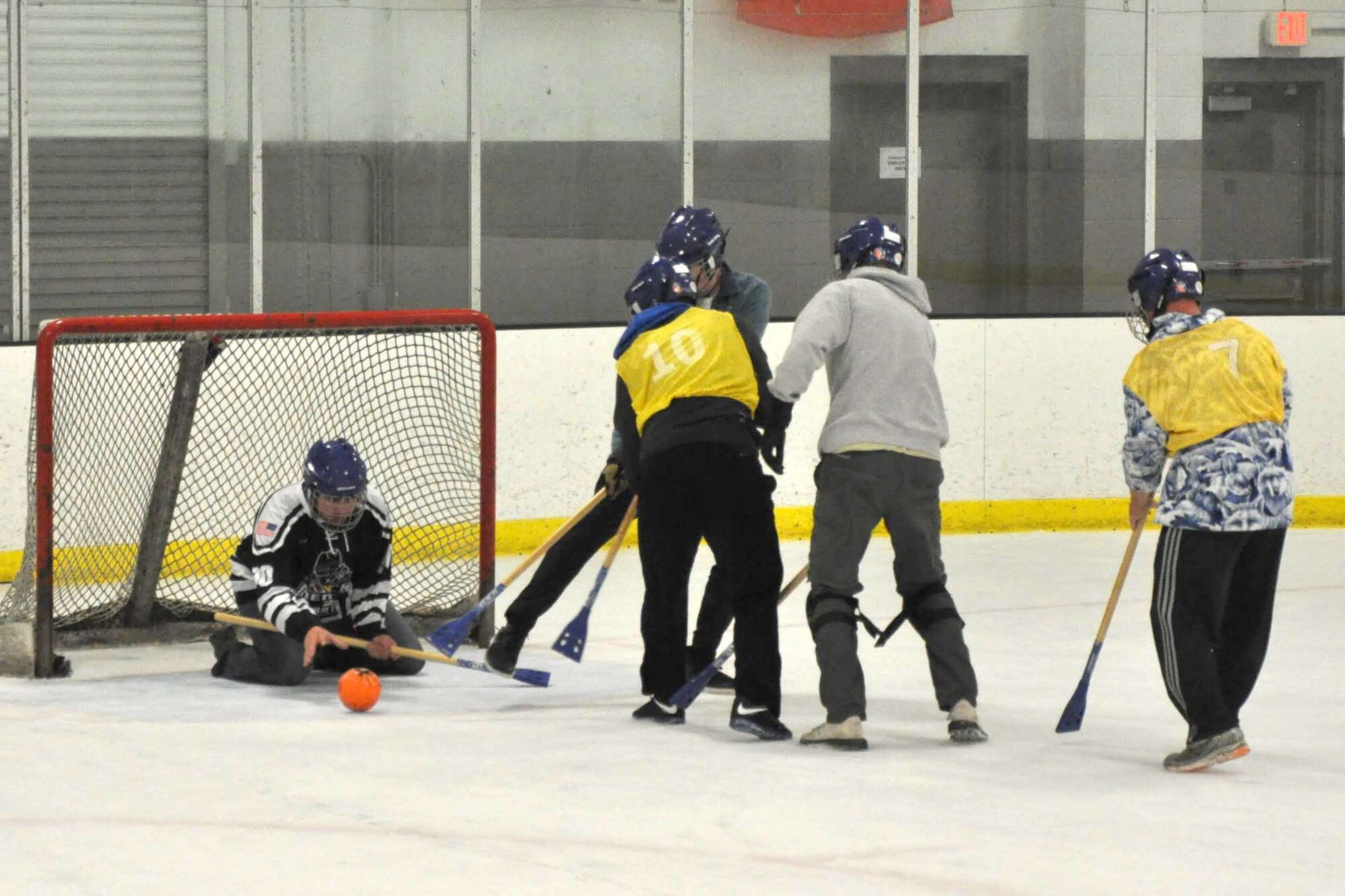 Members of the 38th Reconnaissance Squadron attempt to score while playing a game of Broomball June 21, 2019, at Grover Ice Rink, Omaha, Nebraska. Broomball is one of the many unit cohesion events made possible by the Unite Program established earlier this year. The program is the vision of Gen. David L. Goldfein, Air Force chief of staff, who recognized the need to take care of our squadrons by allowing units to focus on resiliency and cohesion for its members.