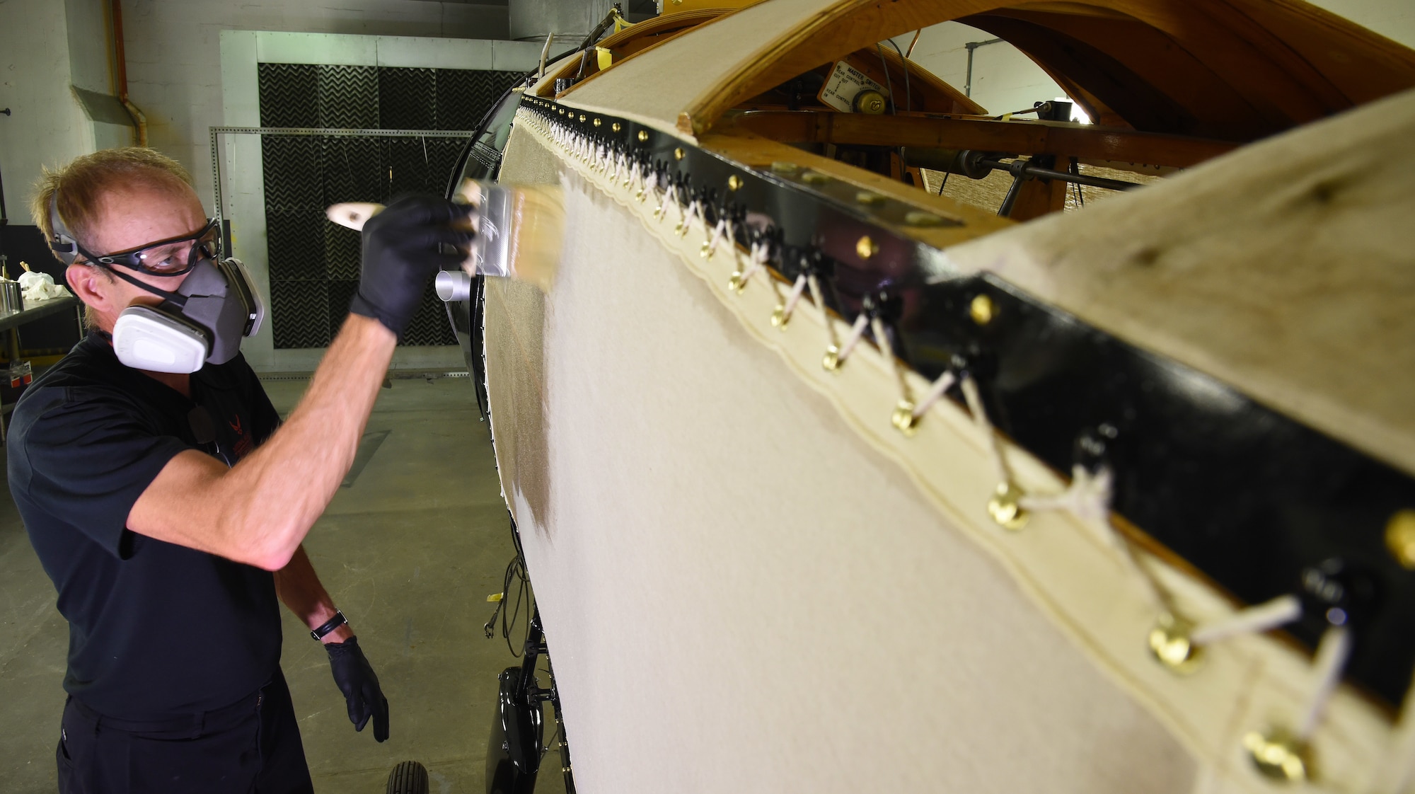 DAYTON, Ohio -- Museum restoration specialist Brian Lindamood applies 50/50 dope to the Avro 504K fuselage on Aug. 7, 2019. This aircraft was originally built in 1966 by the Royal Canadian Air Force's Aircraft Maintenance & Development Unit. Preserving the Air Force's proud legacy, the Restoration Division restores aircraft and aerospace vehicles to historically accurate and visually striking levels. (U.S. Air Force photo by Ken LaRock)