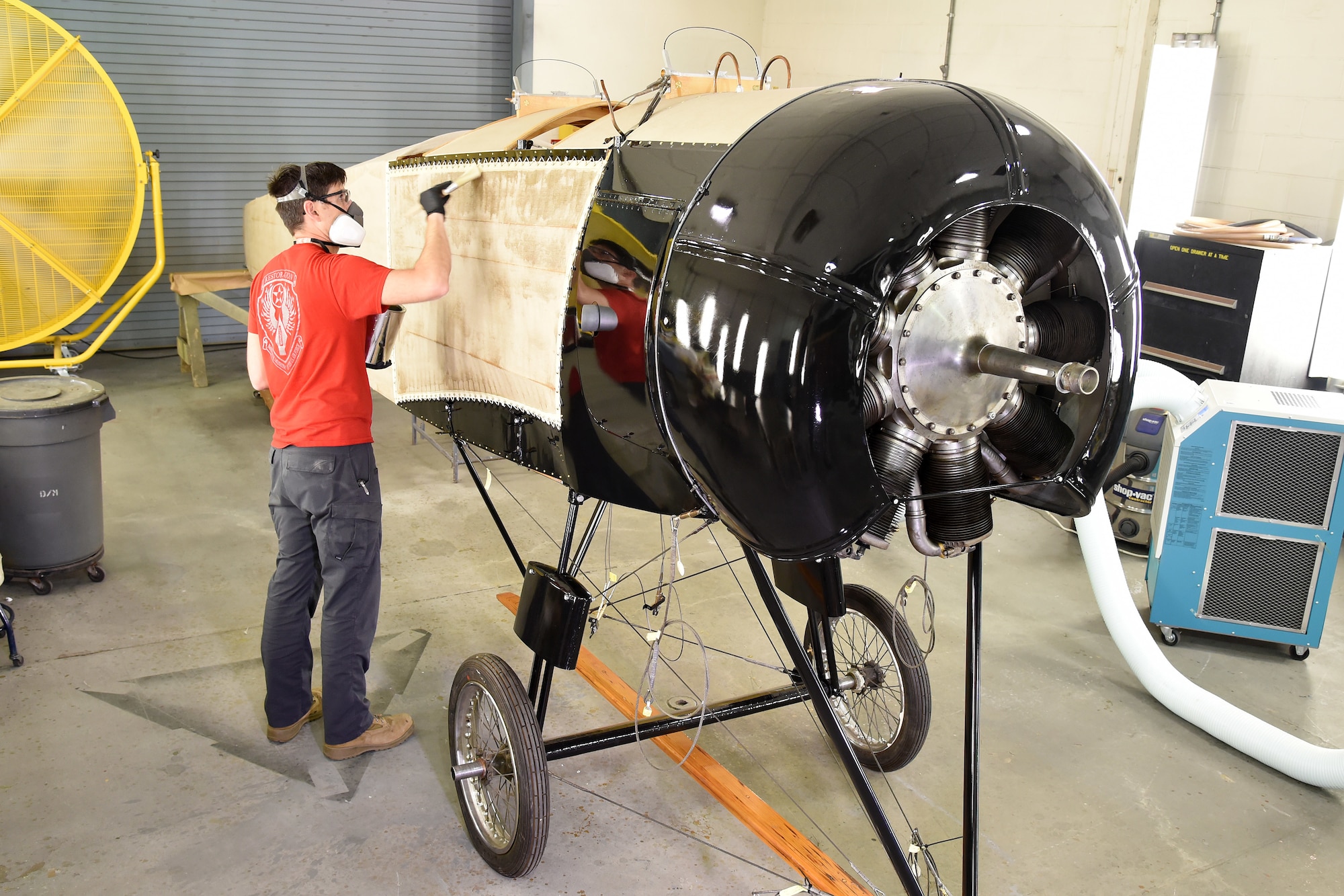 DAYTON, Ohio -- Museum restoration specialist Casey Simmons applies 50/50 dope to the Avro 504K fuselage on Aug. 7, 2019. This aircraft was originally built in 1966 by the Royal Canadian Air Force's Aircraft Maintenance & Development Unit. Preserving the Air Force's proud legacy, the Restoration Division restores aircraft and aerospace vehicles to historically accurate and visually striking levels. (U.S. Air Force photo by Ken LaRock)