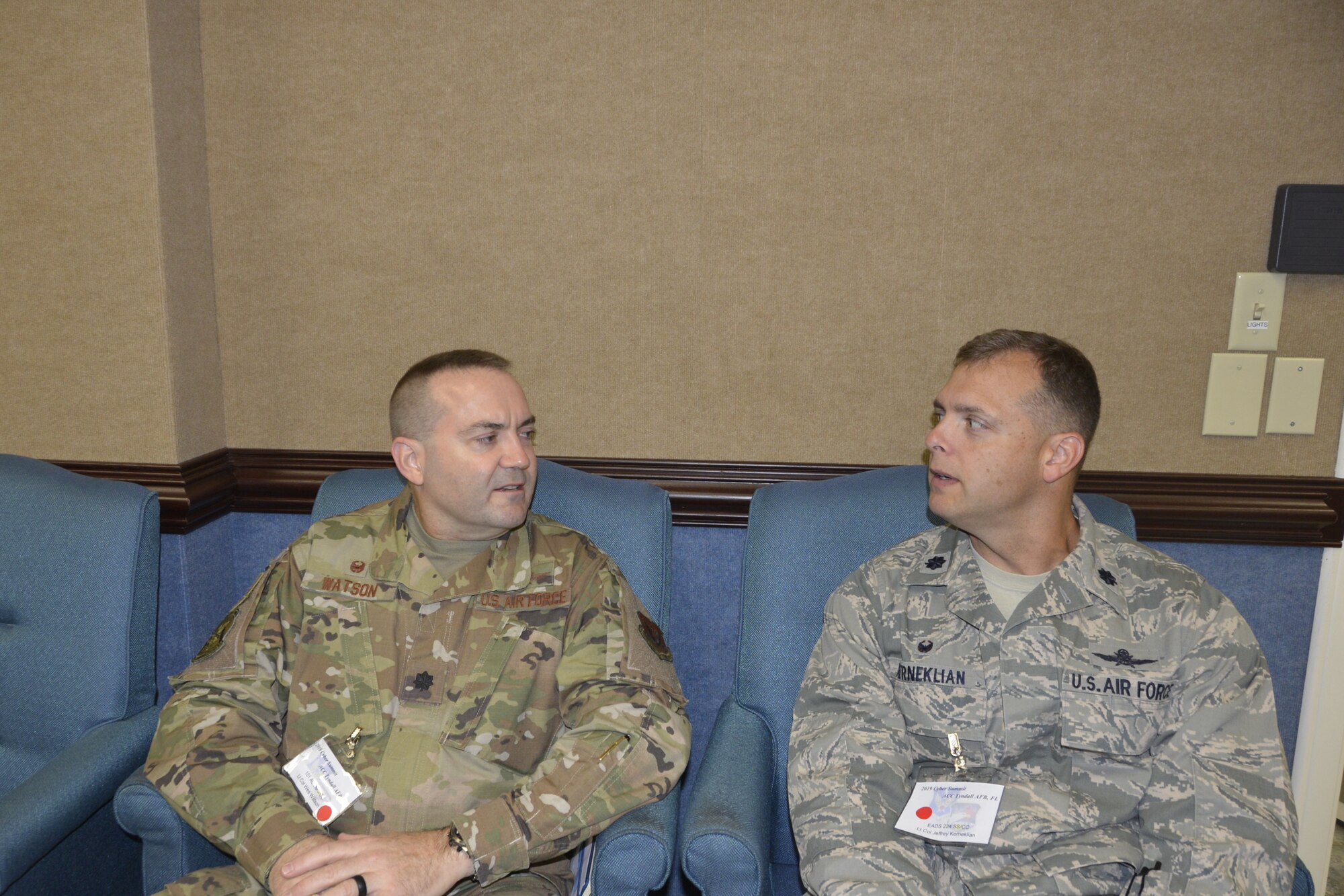 (Left) Lt. Col. Wesley Watson, Commander, 101st Air Communications Squadron, 601st Air Operations Center,  talks with Lt. Col. Lt. Col. Jeffrey Kerneklian, Commander, 224th Support Squadron, Eastern Air Defense Sector, during the 2019 Cyber Summit. (Air Force photo by Mary McHale)