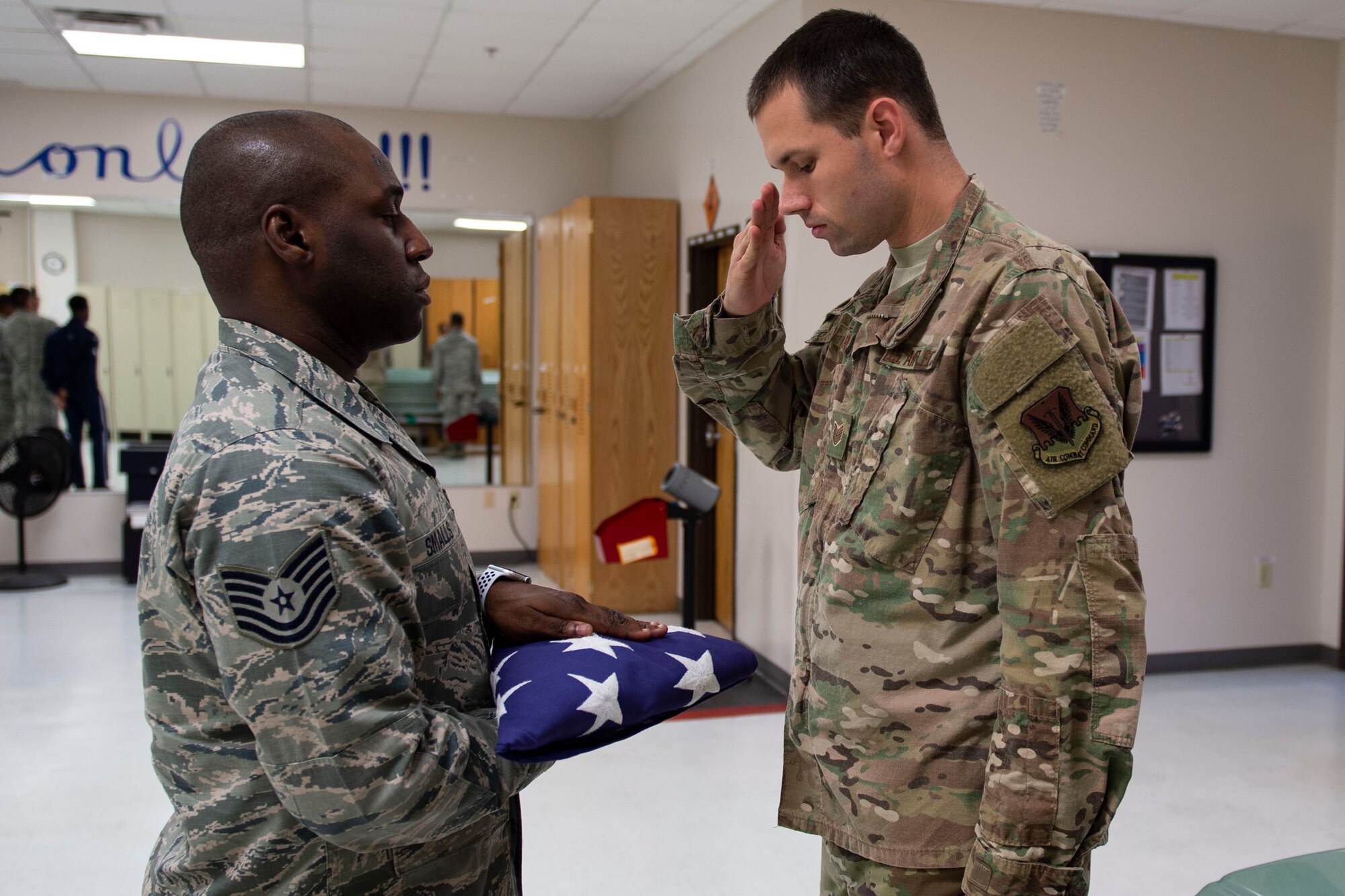 Tech. Sgt. Jesse Larson, right, NCO in charge (NCOIC) of Honor Guard, salutes flag during six-person flag-fold training, July 25, 2019, at Moody Air Force Base, Ga. Tech. Sgt. Jamaal Smalls, NCOIC of Honor Guard, was a master military training instructor (MTI) prior to being a part of Honor Guard. Smalls’ experience as a master MTI helped him develop his professionalism and attention to detail that he now uses in to train Honor Guard members. (U.S. Air Force photo by Airman Azaria E. Foster)