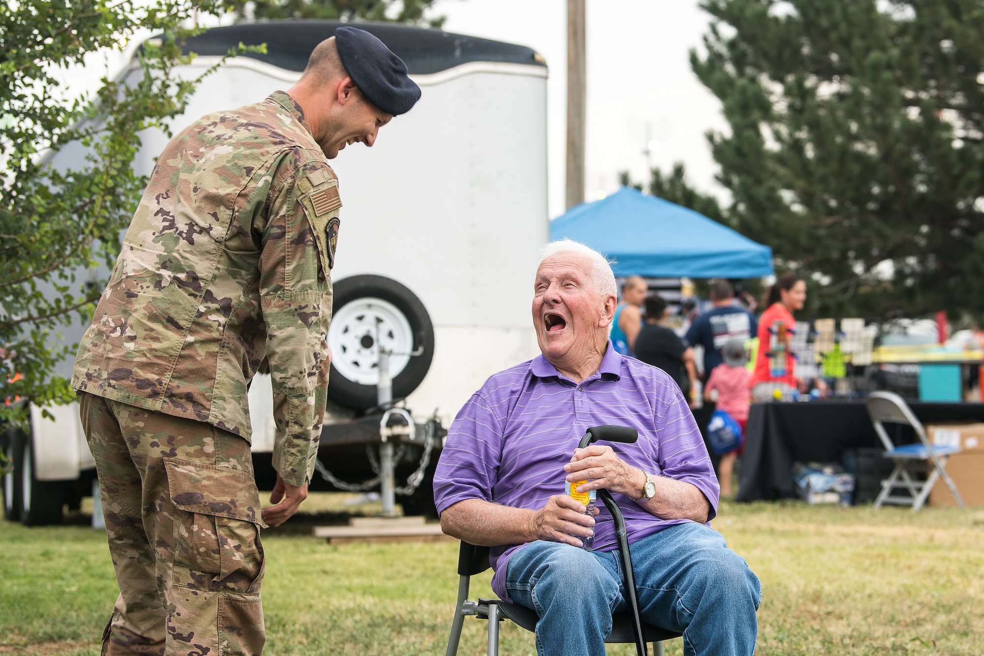 Tech. Sgt. Timothy Norwood, 27th Special Operations Security Forces Squadron kennel master, speaks with a community member during the National Night Out in Clovis, N.M, August 6, 2019. The National Night Out strengthened relationships with law enforcement in the community, including those stationed at Cannon Air Force Base. (U.S. Air Force photo by Senior Airman Vernon R. Walter III)