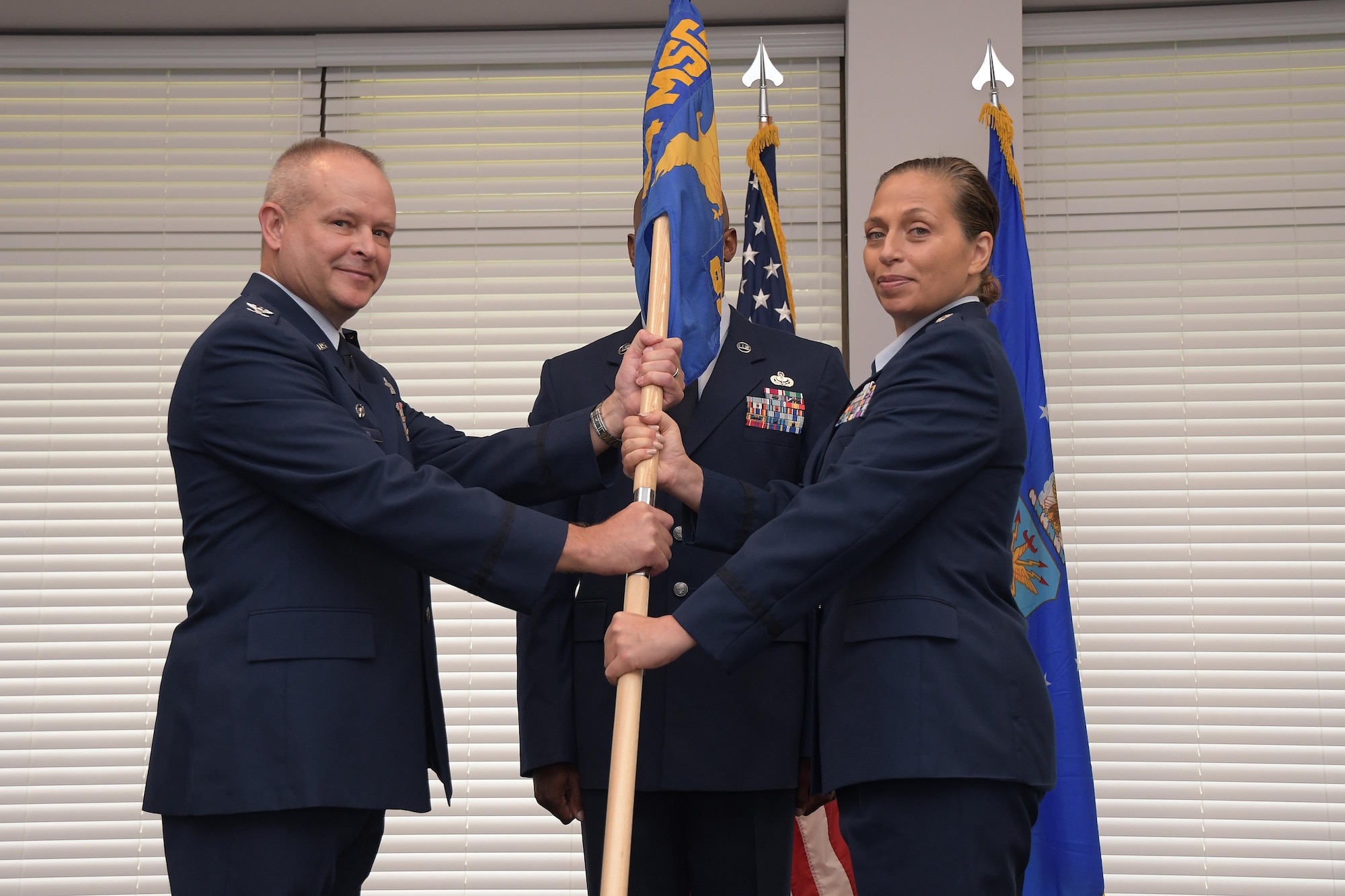 Lt. Col. Suzanne Etedali accepts the guidon from Col. Joseph Revit, 94th Mission Support Group commander during an assumption of command ceremony Aug. 4, 2019.