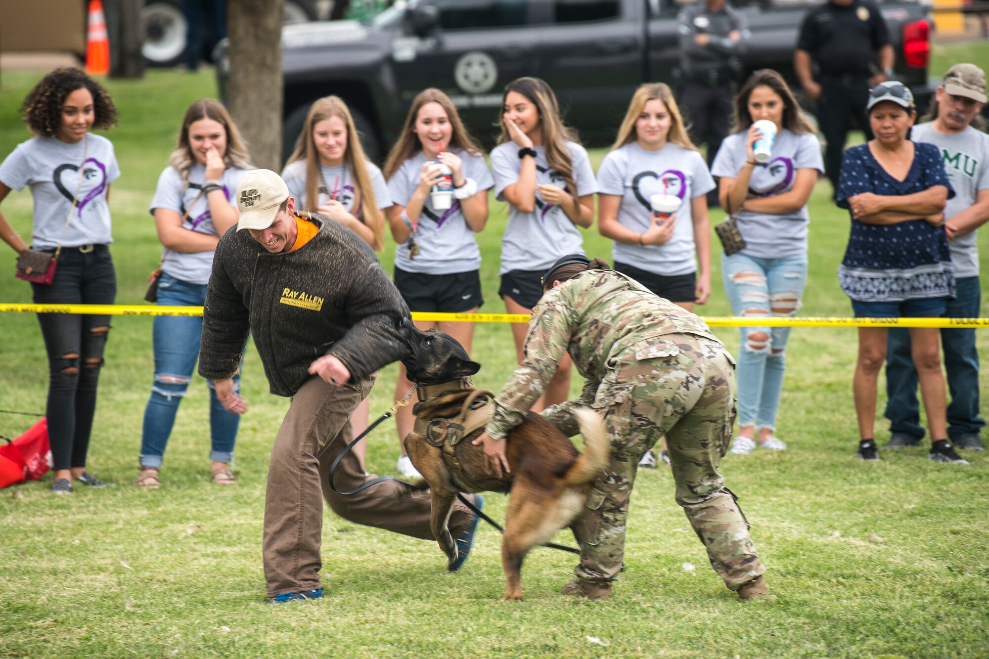 Military working dog Ari Valdo takes down Staff Sgt. Joseph Burke, 27th Special Operations Security Forces Squadron MWD handler, during a demonstration at the National Night Out in Clovis, N.M., August 6, 2019. The demonstration went over different scenarios to show the capabilities of Cannon Air Force Base’s MWDs. (U.S. Air Force photo by Senior Airman Vernon R. Walter III)