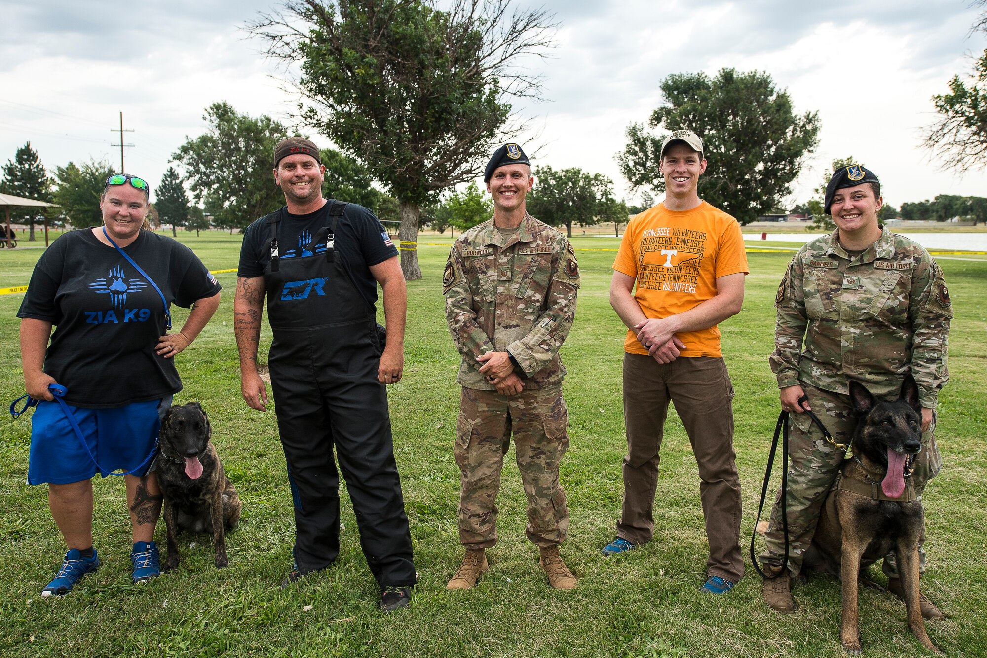 Members of the 27th Special Operations Security Forces Squadron and Zia K-9 pose for a photo after performing a MWD and K-9 demonstration at the National Night Out in Clovis, N.M., August 6, 2019. The display showed the effectiveness of military working dogs and the discipline they have. (U.S. Air Force photo by Senior Airman Vernon R. Walter III)