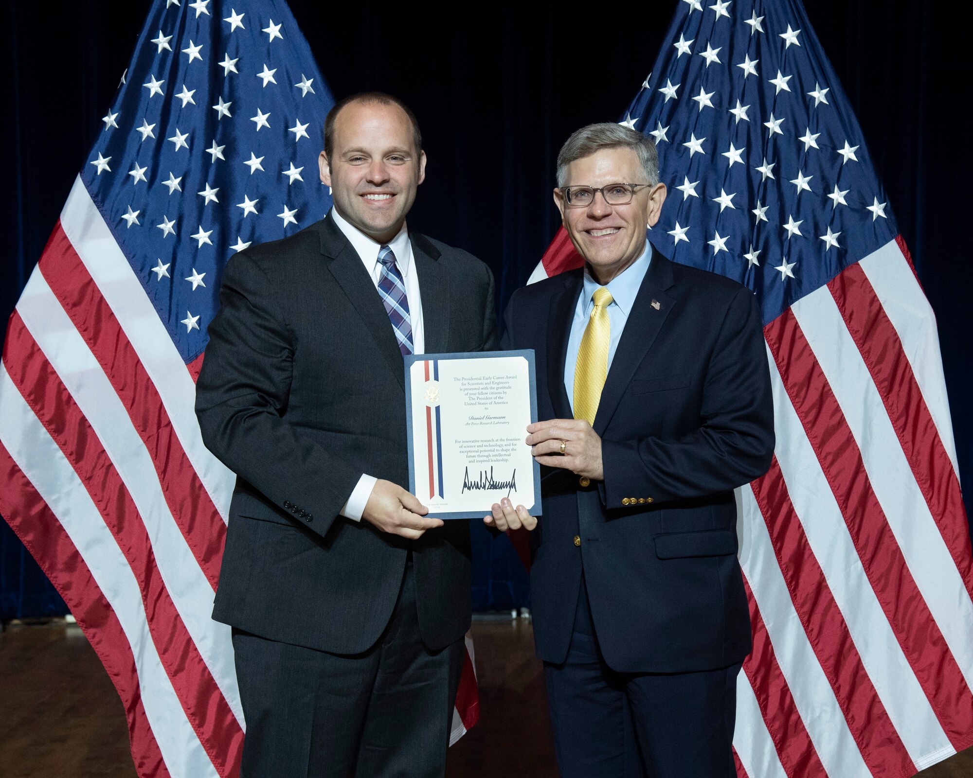 Dr. Daniel Garmann (left) received the Presidential Early Career Award for Scientists and Engineers from Kelvin Droegemeier, director of the Office of Science and Technology Policy, at a July 25, 2019, ceremony in Washington, DC.  (U.S. Department of Energy Photo/Donica Payne)