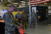 Col. Scott, 432nd Maintenance Group Commander, cuts the ribbon at the Tiger Aircraft Maintenance Unit at Creech Air Force Base, Nevada, July 29, 2019.  Prior to this grand opening, all Airmen were tasked with getting their tools from the Reaper Aircraft Maintenance Unit. (U.S. Air Force photo by Airman 1st Class William Rio Rosado)