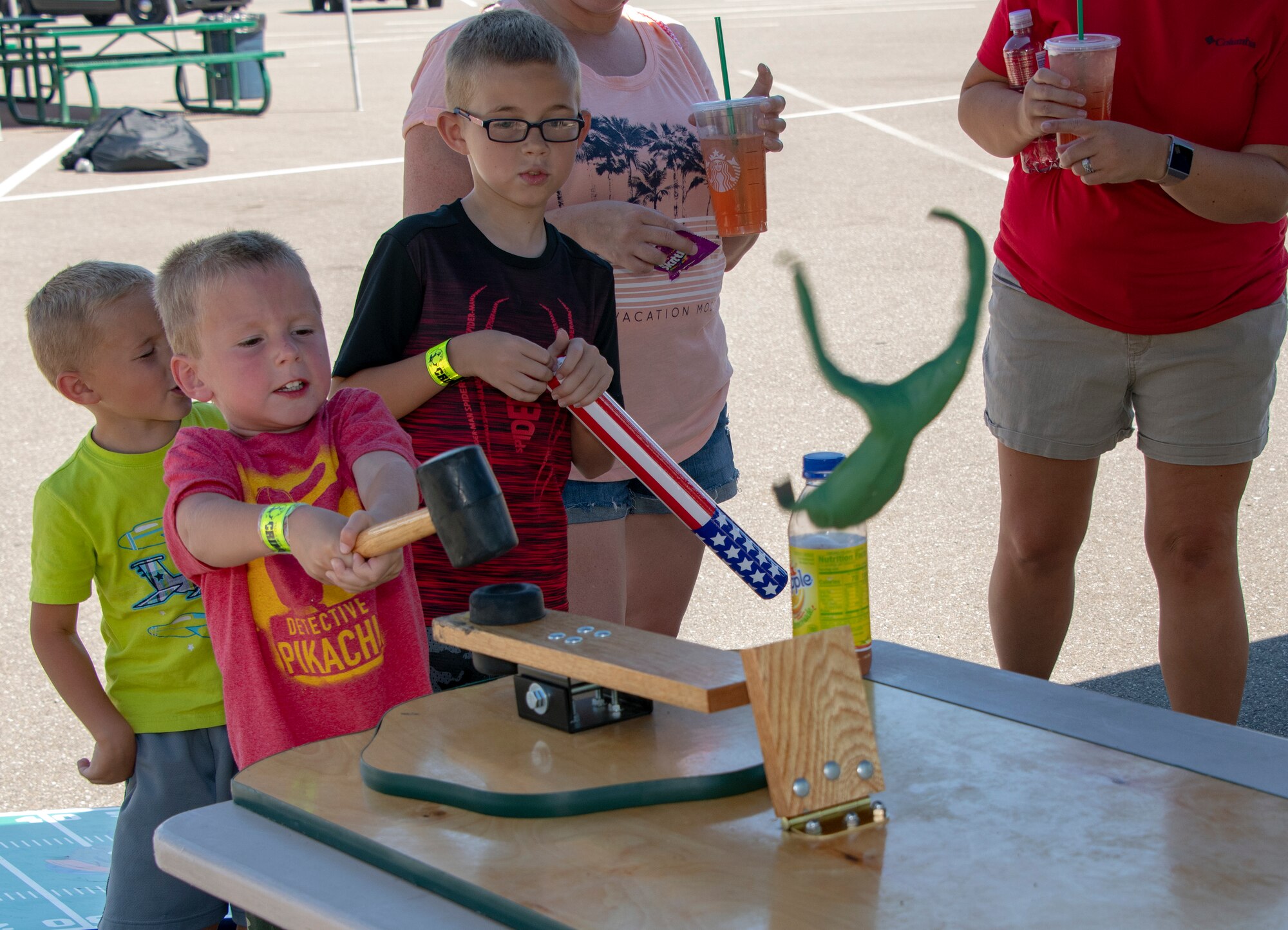 Children play a game during the 60th Security Forces Squadron National Night Out Aug. 6, 2019, at Travis Air Force Base, California. National Night Out is an annual community-building campaign that promotes police-community partnerships and neighborhood camaraderie. The event included a demonstration by military working dogs, live music and a variety of activities for children. (U.S. Air Force photo by Heide Couch)
