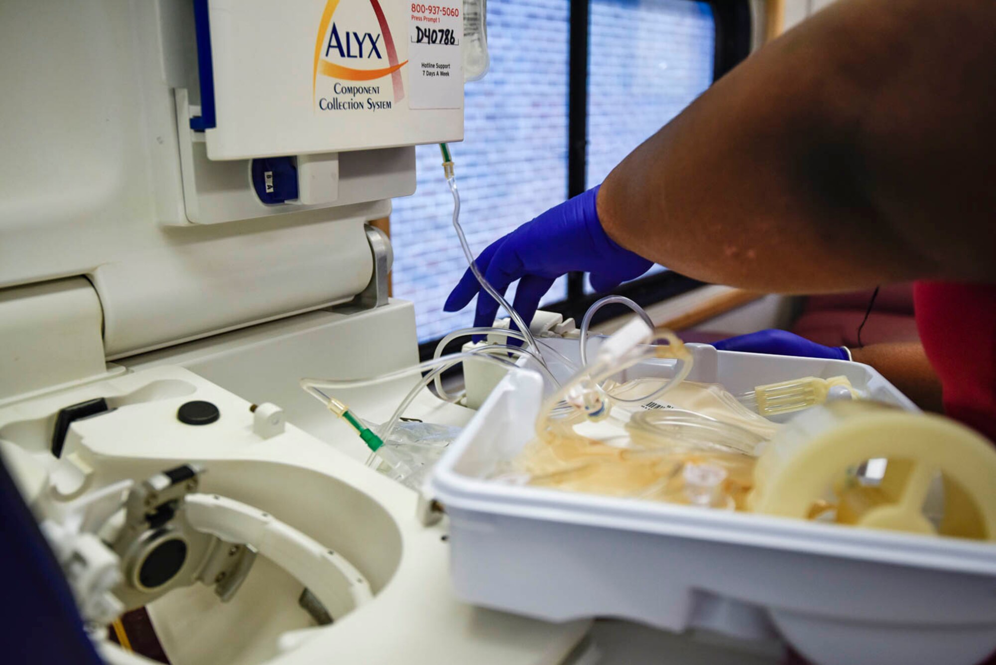 A collection specialist from the Arkansas Blood Institute prepares equipment to draw blood from an Airman during the blood drive at Little Rock Air Force Base, Ark., August 4, 2019. The blood donation is a four-step process: registration, medical history and mini-physical, followed by the donation. Each donation of 1-pint can contribute to saving up to 3 lives. While Airmen’s main focus is readiness training during Unit Training Assembly, the blood drive allowed Airmen to take a break from training and give back to the community. (U.S. Air Force photo by Senior Airman Nathan Byrnes)