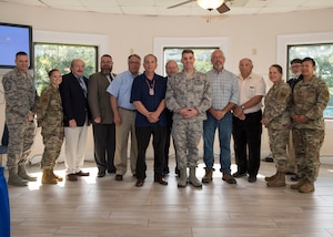 Joint Base Langley-Eustis leaders and members from four Native American groups pose for a photo during a tribe consultation tour at Fort Eustis, Virginia, Aug. 7, 2019.