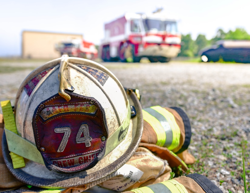 An 11th Civil Engineer Squadron fire safety helmet is left on the ground while 11th CES firefighters assist cadets during the Fire Explorer Program on Joint Base Andrews, Md., July 27, 2019. Members of the JBA fire department have been orchestrating the FEP for over three years.