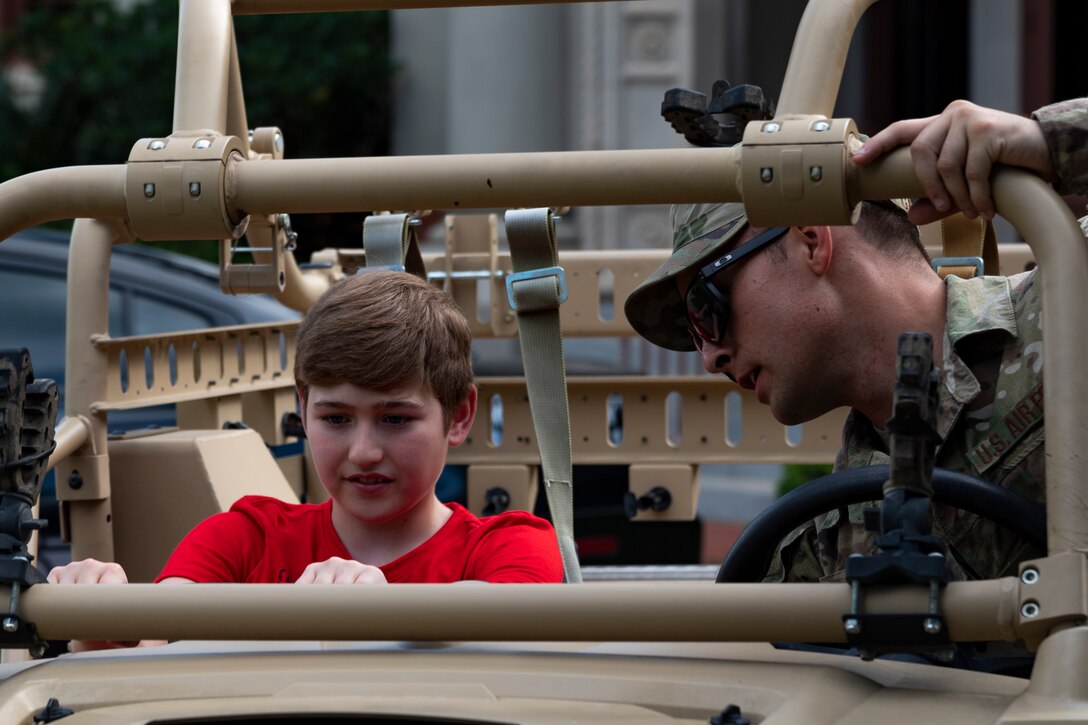 Airman 1st Class Louis Cashell, 824th Base Defense Squadron fire team member, engages with a participant of National Night Out at the main campus of Valdosta State University Aug. 6, 2019, in Valdosta, Ga. National Night Out is an annual event that promotes relationships between police and the community in an effort to prevent crime. Representatives from Team Moody participated to create local community awareness and build support for the Air Force mission. (U.S. Air Force photo by Airman 1st Class Hayden Legg)