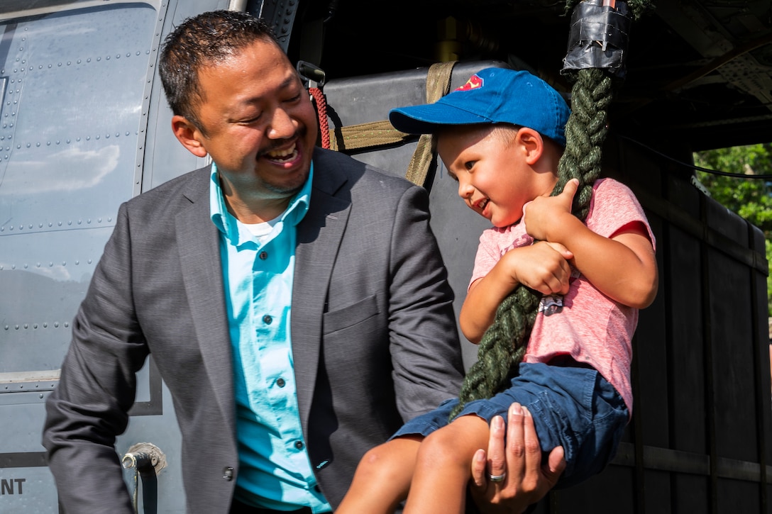 Participants of National Night Out tour an HH-60G Pave Hawk at the main campus of Valdosta State University Aug. 6, 2019, in Valdosta, Ga. National Night Out is an annual event that promotes relationships between police and the community in an effort to prevent crime. Representatives from Team Moody participated to create local community awareness and build support for the Air Force mission. (U.S. Air Force photo by Airman 1st Class Hayden Legg)