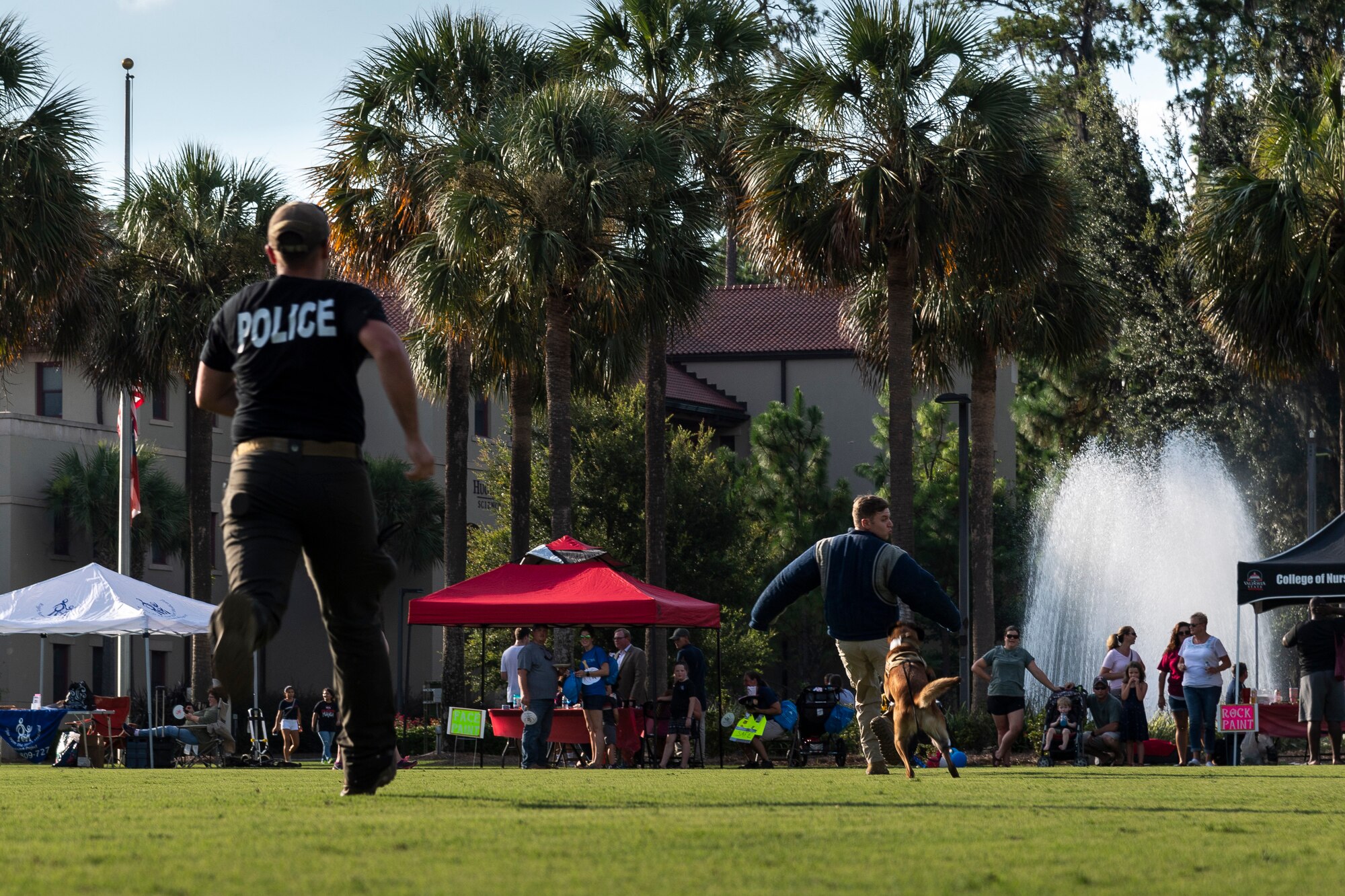 Airmen assigned to the 23d Security Forces Squadron (SFS) perform a military working dog demonstration during National Night Out at the main campus of Valdosta State University Aug. 6, 2019, in Valdosta, Ga. National Night Out is an annual event that promotes relationships between police and the community in an effort to prevent crime. Representatives from Team Moody participated to create local community awareness and build support for the Air Force mission. (U.S. Air Force photo by Airman 1st Class Hayden Legg)