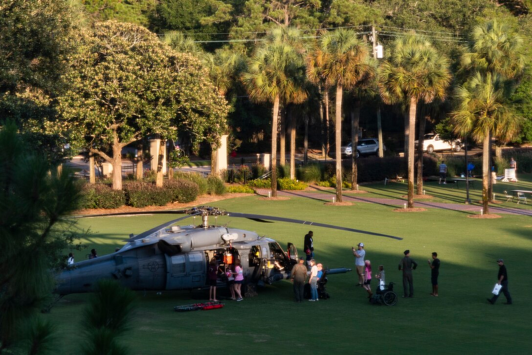 Participants of National Night Out tour an HH-60G Pave Hawk at the main campus of Valdosta State University Aug. 6, 2019, in Valdosta, Ga. National Night Out is an annual event that promotes relationships between police and the community in an effort to prevent crime. Representatives from Team Moody participated to create local community awareness and build support for the Air Force mission. (U.S. Air Force photo by Airman 1st Class Hayden Legg)