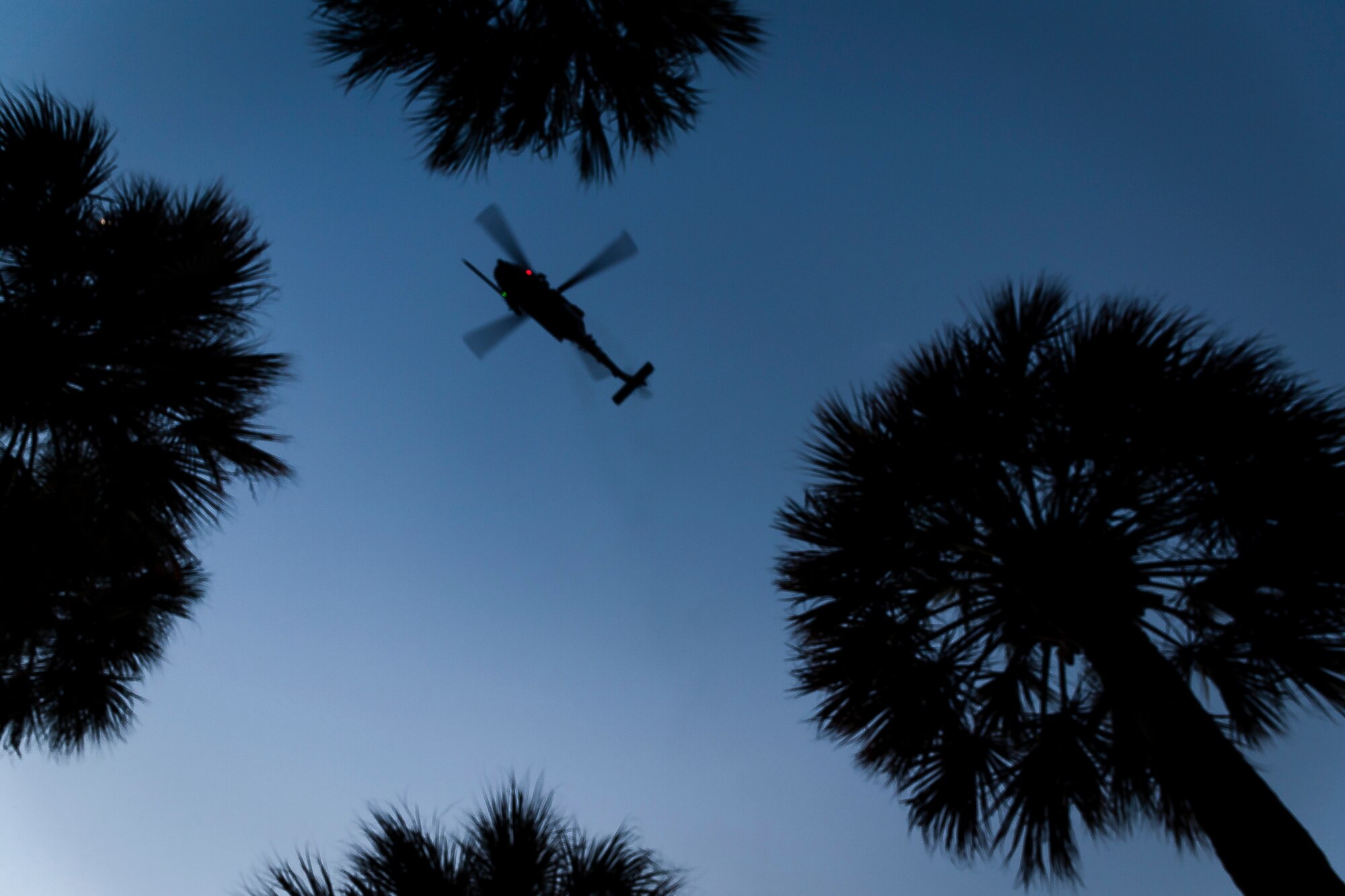 An HH-60G Pave Hawk flies over Valdosta State University after National Night Out Aug. 6, 2019, in Valdosta, Ga. National Night Out is an annual event that promotes relationships between police and the community in an effort to prevent crime. Representatives from Team Moody participated to create local community awareness and build support for the Air Force mission. (U.S. Air Force photo by Airman 1st Class Hayden Legg)