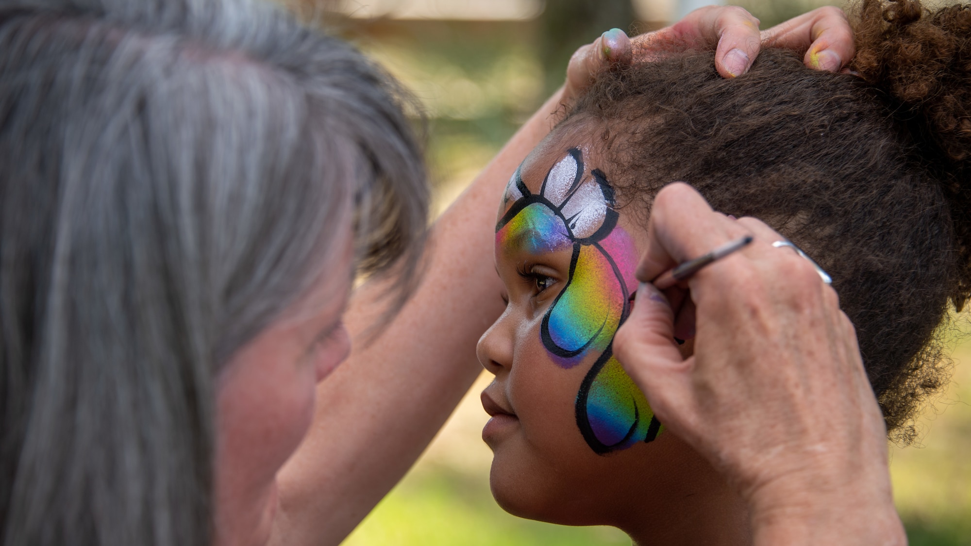 Delainie Rice gets her face painted during the annual Salute Picnic at Hill Air Force Base, Utah, Aug. 2, 2019. This was the 19th year the Top of Utah Military Affairs Committee  sponsored the event for Hill's military and family members. The first event was held December 2001 as a welcome home celebration for military deployed following 9/11. (U.S. Air Force photo by R. Nial Bradshaw)