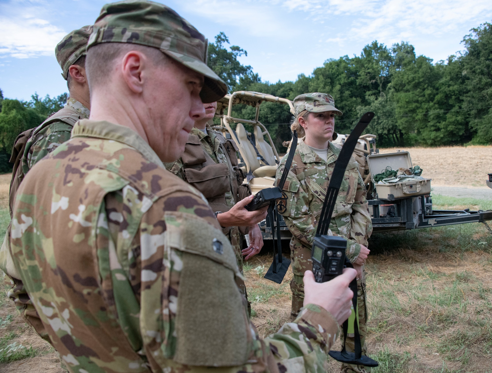 U.S. Air Force Maj. Justin Krull, 6th Air Refueling Squadron KC-10 Extender instructor pilot listens to last minute instruction on communication devices before a Survival, Evasion, Resistance and Escape training exercise for aircrew members that will last well into the evening Aug. 5, 2019, in a remote area near Travis Air Force Base, California. SERE instructors conduct the training to improve aircrew’s skill sets and update them on new techniques, procedures and technologies. (U.S. Air Force photo by Heide Couch)