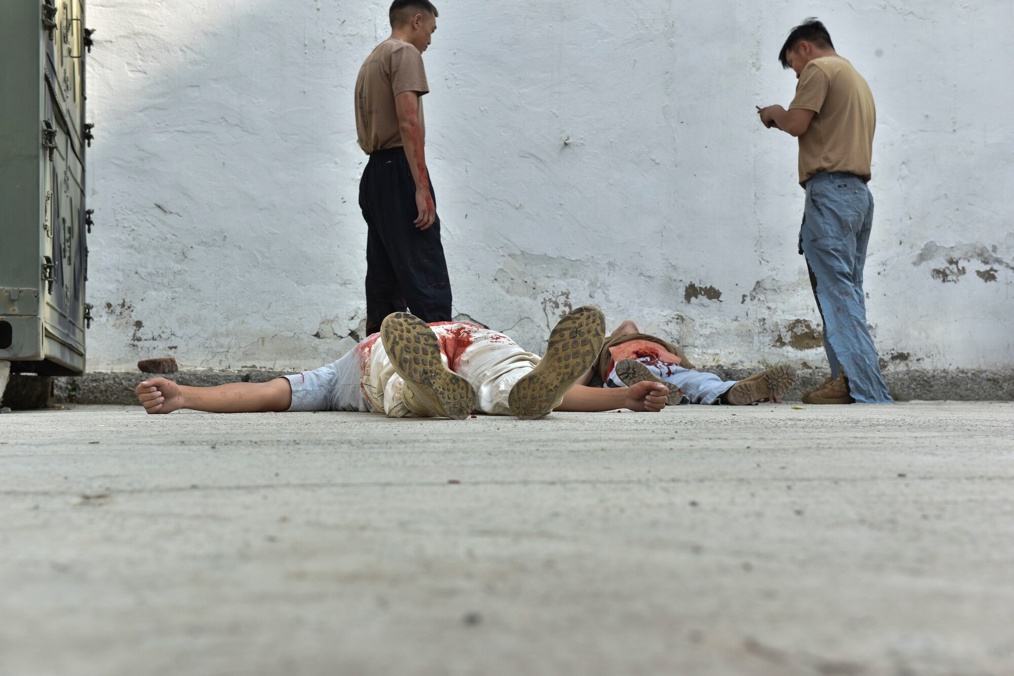 Two simulated casualties lie on the ground waiting for a mass casualty exercise to begin Aug. 1, 2019, during Pacific Angel 19-3 in Ulaanbaatar, Mongolia. PAC ANGEL is a joint and combined humanitarian assistance engagement, enhancing participating nations’ humanitarian assistance and disaster relief capabilities while providing beneficial services to people in need throughout South and East Asia. (U.S. Air Force photo by Senior Airman Eric M. Fisher)