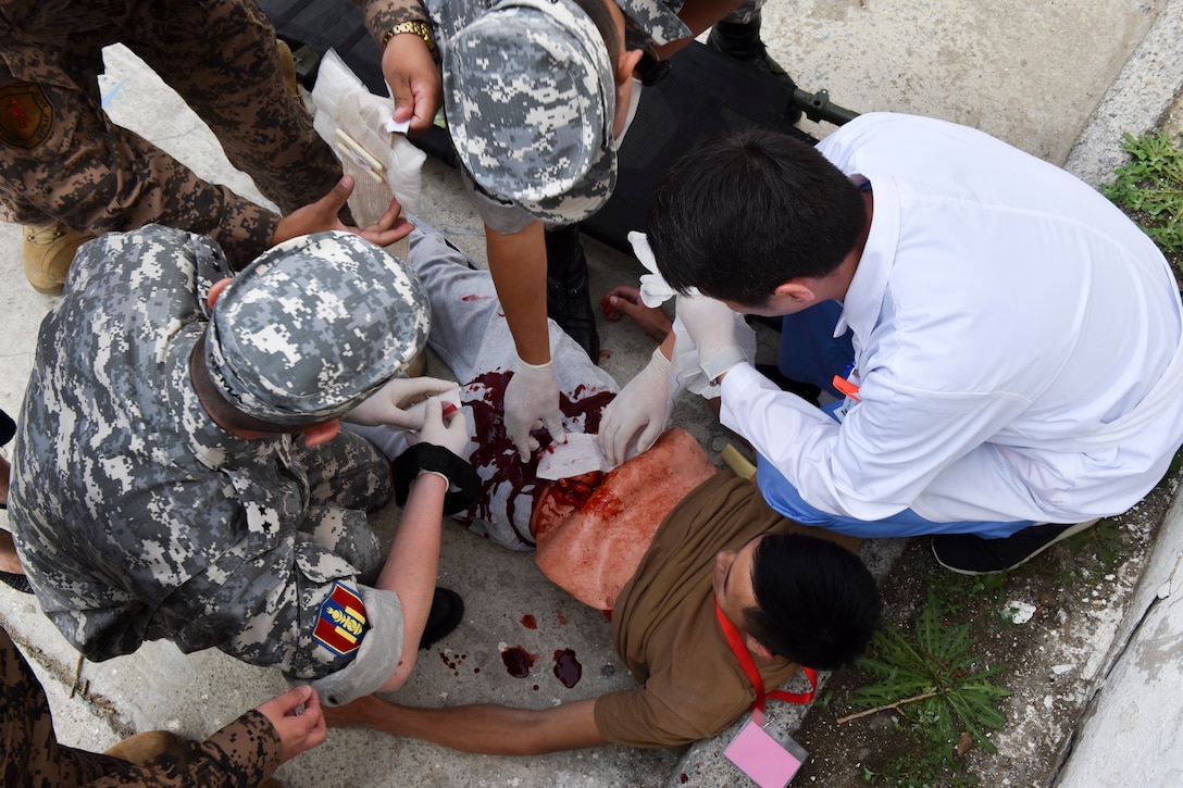 Mongolian Armed Forces medical personnel treat the wounds of a simulated casualty Aug. 1, 2019, during Pacific Angel 19-3 in Ulaanbaatar, Mongolia. Efforts undertaken during PAC ANGEL help the U.S. and partner nations improve and build relationships across a wide spectrum of civic engagements, bolstering each nation’s capacity to respond and support future humanitarian assistance and disaster relief operations. (U.S. Air Force photo by Senior Airman Eric M. Fisher)
