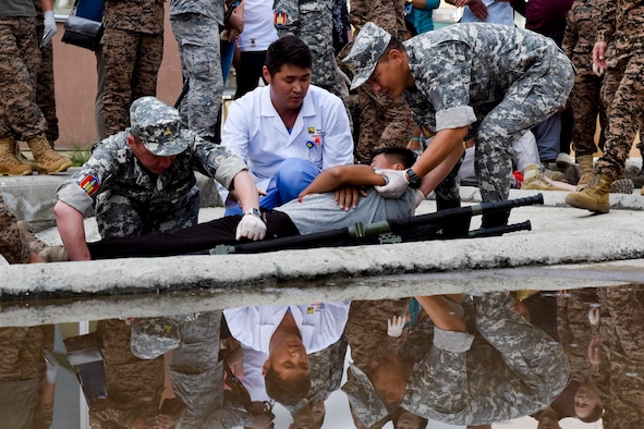 Mongolian Armed Forces medical personnel move a simulated casualty patient onto a litter Aug. 1, 2019, during Pacific Angel 19-3 in Ulaanbaatar, Mongolia. PAC ANGEL is a multilateral humanitarian assistance civil military engagement, improving military-to-military partnerships in the pacific through medical health outreach, civic engineering projects and subject matter expert exchanges between U.S. service members, multinational militaries, nongovernmental organizations, and Mongolian military and civilian participants. (U.S. Air Force photo by Senior Airman Eric M. Fisher)