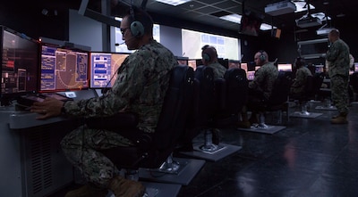 IMAGE: 190611-N-HV059-1063 NORFOLK (June 11, 2019) Sailors train on consoles in a simulated combat information center at Center for Surface Combat Systems’ (CSCS) Combined Integrated Air and Missile Defense (IAMD) / Anti-Submarine Warfare (ASW) Trainer (CIAT), onboard Naval Base Norfolk.  CSCS’ main mission is to develop and deliver surface ship combat systems training to the fleet and achieve surface warfare superiority. (U.S. Navy photo by Mass Communication Specialist 2nd Class Sonja Wickard/Released)