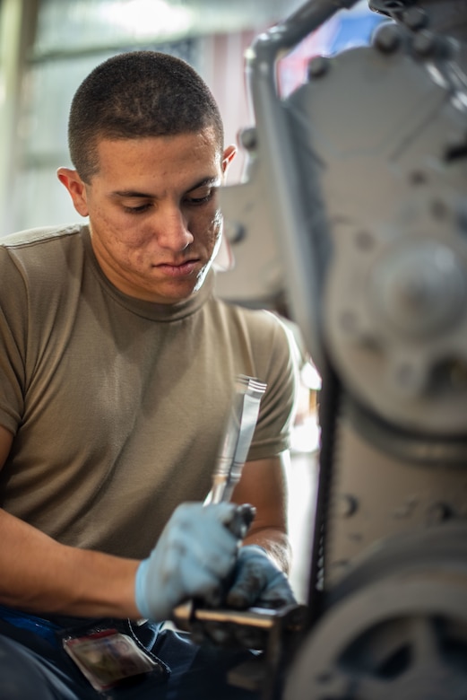 Staff Sgt. Adan Nunez, 380th Expeditionary Maintenance Squadron aerospace ground equipment craftsman, attaches an alternator to a four-cylinder diesel engine July 30, 3019, at Al Dhafra Air Base, United Arab Emirates. The engine provides power to a -86 generator which delivers 115 watts to the aircraft. (U.S. Air Force photo by Staff Sgt. Chris Thornbury)