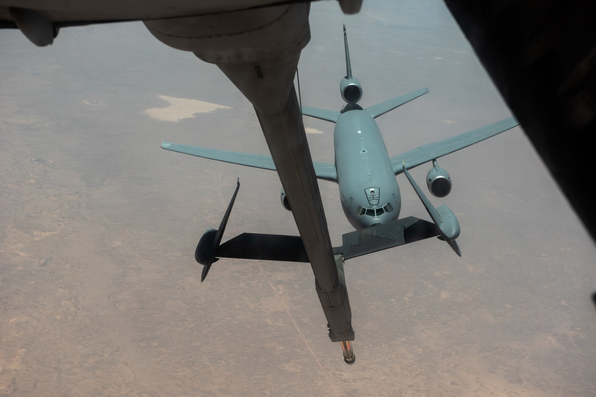 A 908th Expeditionary Air Refueling Squadron KC-10 Extender flies below another KC-10 after receiving fuel Aug. 6, 2019. The KC-10 is able to offload and receive fuel to stay in the air longer to support operations throughout the area of operations. (U.S. Air Force photo by Staff Sgt. Chris Thornbury)