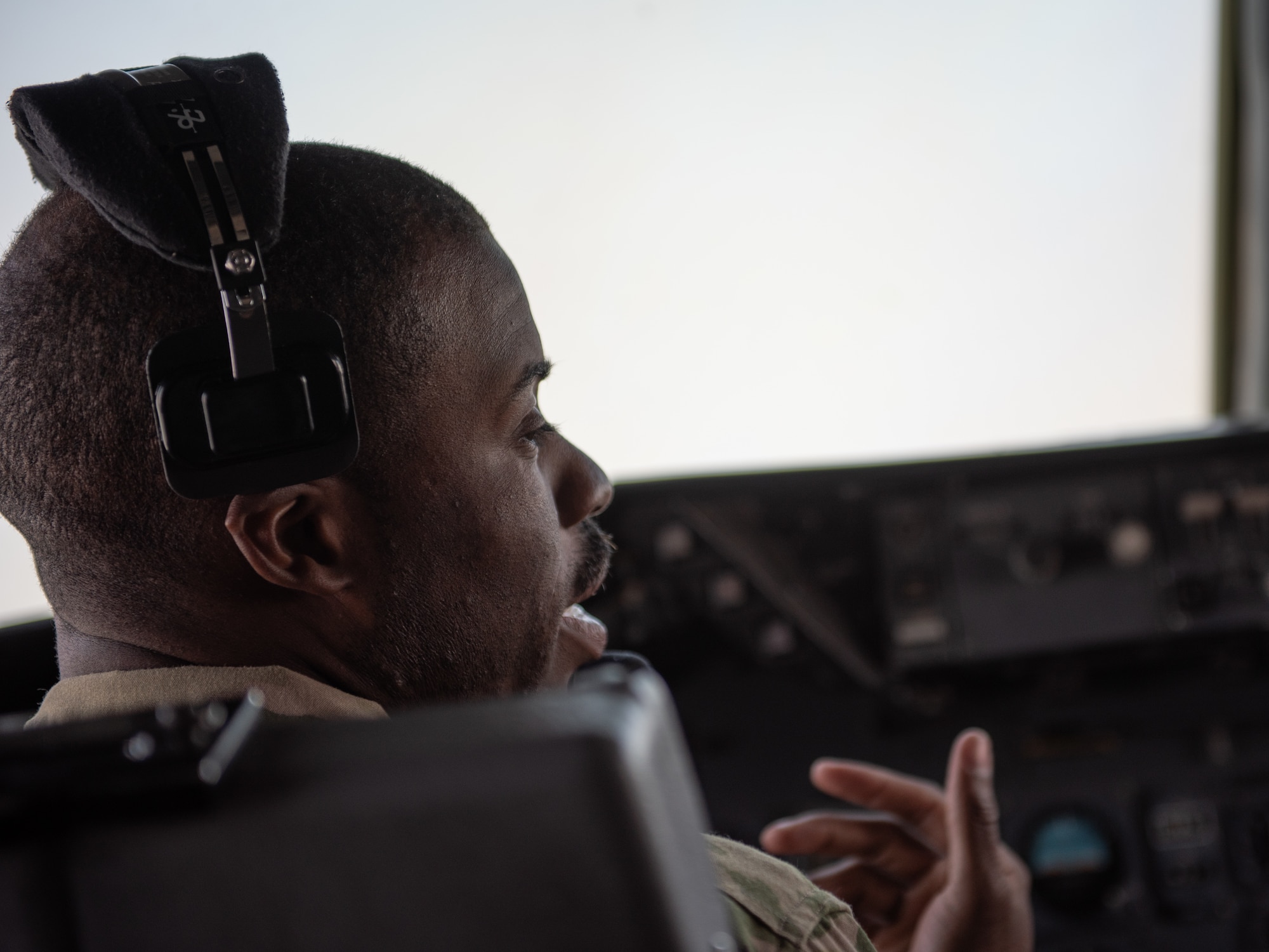 Capt. Chris Tobiere, 908th Expeditionary Air Refueling Squadron KC-10 Extender pilot, talks with his co-pilot during a mission Aug. 6, 2019. During their flight the crew supported exercise Agile Lightning and refueled another KC-10. (U.S. Air Force photo by Staff Sgt. Chris Thornbury)