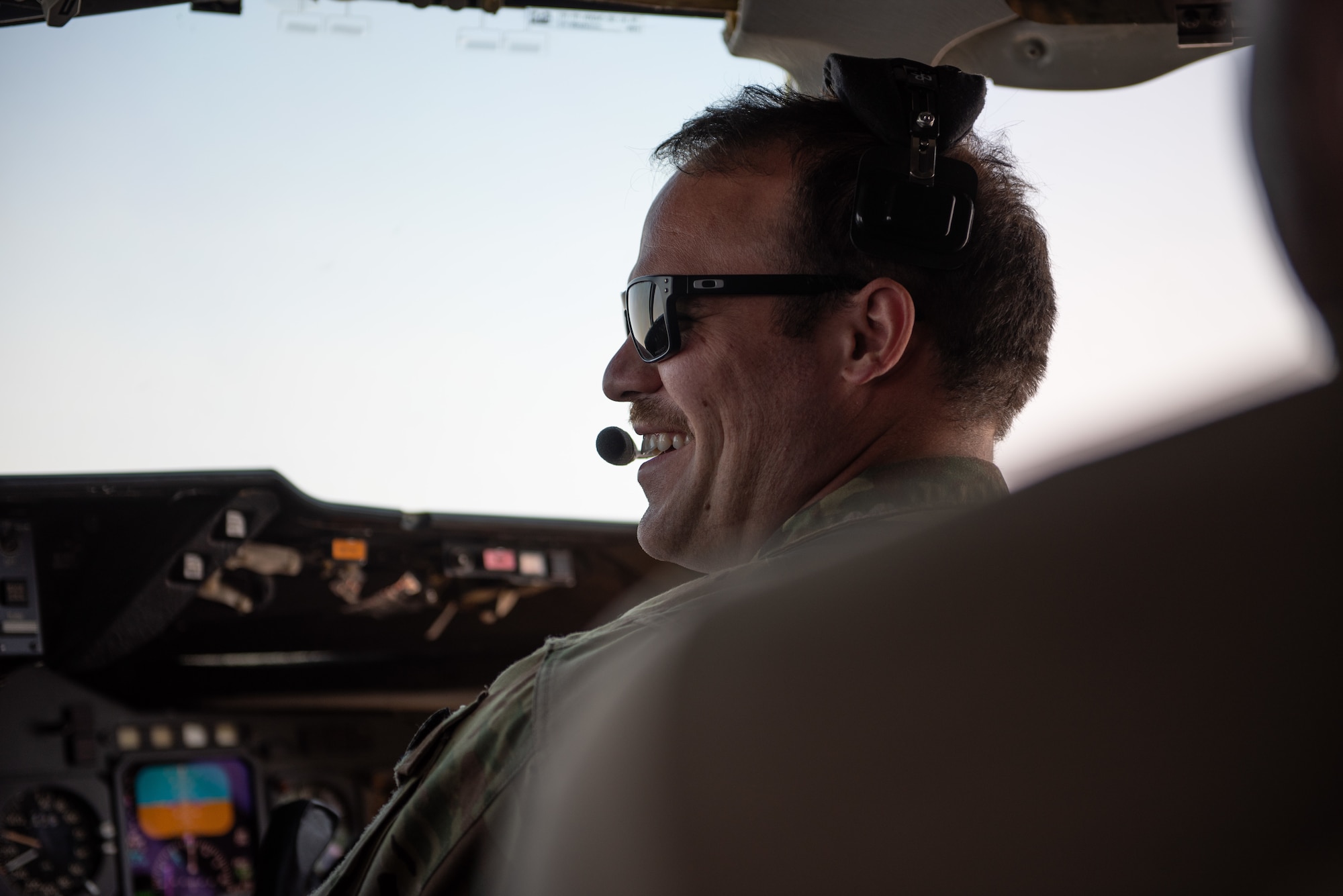 Capt. David Miller, 908th Expeditionary Air Refueling Squadron KC-10 Extender pilot, talks with another pilot during a mission Aug. 6, 2019. During their flight the crew supported exercise Agile Lightning and refueled another KC-10. (U.S. Air Force photo by Staff Sgt. Chris Thornbury)