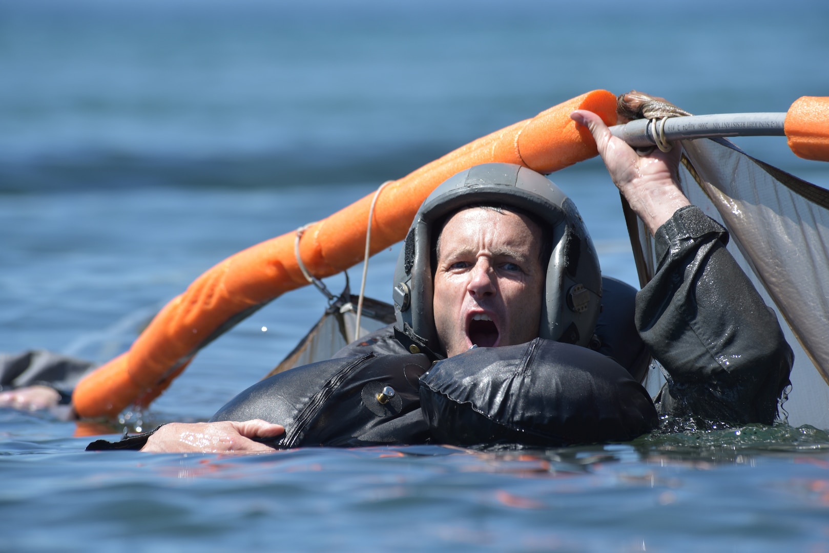 U.S. Air Force Lt. Col. Kedric Osborne, an F-15C Instructor Pilot at the 173rd Fighter Wing, takes a deep breath before submerging beneath a floating parachute canopy during water survival training at Cultus Lake, Oregon, July 25, 2019.