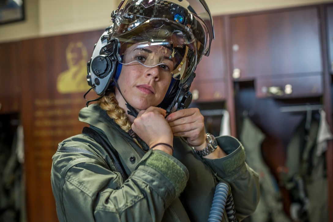 Capt. Anneliese Satz puts on her flight helmet prior to a training flight aboard Marine Corps Air Station Beaufort, March 11. Satz graduated the F-35B Lighting II Pilot Training Program June and will be assigned to Marine Fighter Attack Squadron 121 in Iwakuni, Japan.