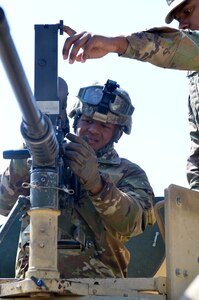 Private 1st Class Jonathan Cruzarce (right), 439th Quartermaster Co., 316th Sustainment Command (Expeditionary), assists Sgt. Christopher Downie (left), in the same unit, with attaching a thermal weapon sight to an M2.50 caliber machine gun on a mounted gunnery range during Operation Cold Steel Task Force Fortnite hosted by the 377th Theater Sustainment Command at Ft. McCoy, Wis. April 16, 2019.