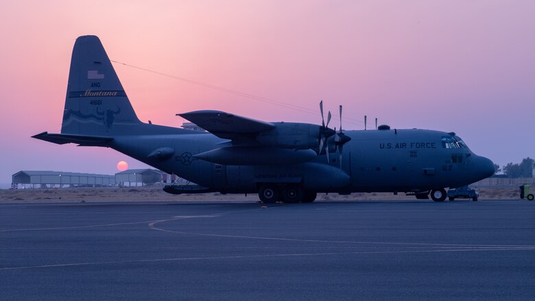 A C-130 Hercules sits on the ramp