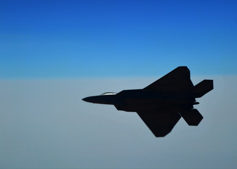 An F-22 Raptor flies above an undisclosed location