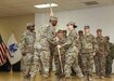 1st Lt. Caroline C. Shaw, outgoing commander Headquarters and Headquarters Company (HHC),, 335th Signal Command (Theater) (Provisional), passes the colors to Brig. Gen. Dion B. Moten, commanding general 335th SC (T)(P), during a combined Change of Command and Change of Responsibility Ceremony at Camp Arifjan, Kuwait, August 2, 2019. Capt. William A. Brinson and 1st Sgt. Yesenia S. Cooper formally accepted the command team reins of HHC, 335th SC (T) (P) from 1st Lt. Caroline C. Shaw and 1st Sgt. Shéshé A. Lang.