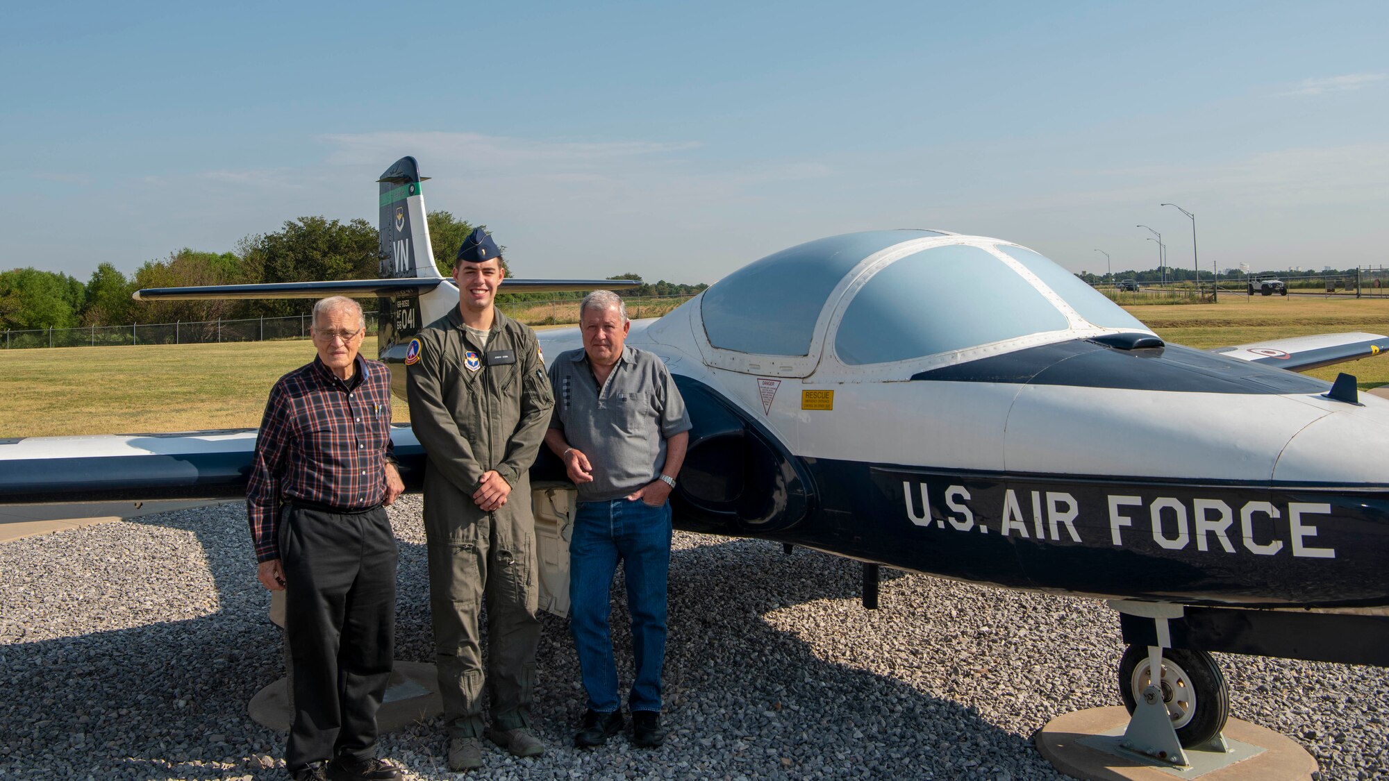 2nd Lt. Joe Stara, center, a student pilot currently assigned to the 71st Student Squadron, poses by a T-37 Tweet with retired Col. Jim Faulkner, left, and retired Lt. Col. Jim Mayhall, Aug. 6, at Vance Air Force Base, Okla. Faulkner and Mayhall were both student pilots at Vance AFB in the late 1960s. (U.S. Air Force photo by Airman 1st Class Octavius Thompson)