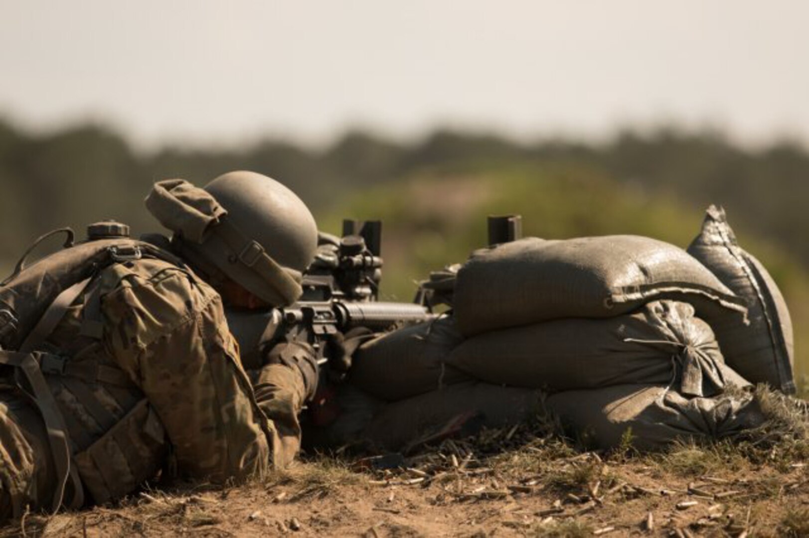 A Soldier from the 1166th Transportation Company, Massachusetts National Guard, engages a target during a base defense live-fire exercise during the Combined Arms Exercise: Patriot Crucible on Camp Edwards, Mass., on  Aug. 4, 2019. The Soldiers of the 1166th participated in several iterations of this training event without ammunition and with blank ammunition in order to hone their skills in tactical maneuvers and fire.
