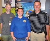 IMAGE: KING GEORGE, Va. (July 30, 2019) – Navy human factors engineer Chelsey Lawson, middle, is pictured with her former high school teachers at the Naval Surface Warfare Center Dahlgren Division (NSWCDD) STEM Workshop for Educators at the University of Mary Washington Dahlgren campus. Lawson was among the NSWCDD scientists and engineers who joined university professors at the workshop to share best practices and ideas for project based learning in STEM with elementary, middle, and high school educators. Standing left to right at the workshop is Jeremy Webb from Spotsylvania High School; Lawson; and Jim McNamee from Commonwealth Governor’s School.  “Mr. Webb was my drafting teacher and Mr. McNamee was my math teacher for three years,” said Lawson. “They were both very encouraging and influential not only in my high school education but also in choosing to be an engineer because they made STEM subjects interesting.”