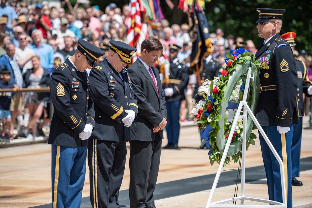 People stand at a ceremony.