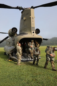 Airborne Soldiers participating in the Leapfest International Airborne Competition in South Kingstown, Rhode Island exit a CH-47 flown by Soldiers from the New York Army National Guard's Bravo Company, 3rd Battalion, 126th Aviation. Soldiers from Bravo Company, 3rd Battalion, 126th Aviation, based in Rochester, N.Y., have been providing support to the Rhode Island National Guard's Leapfest competition since 2011.