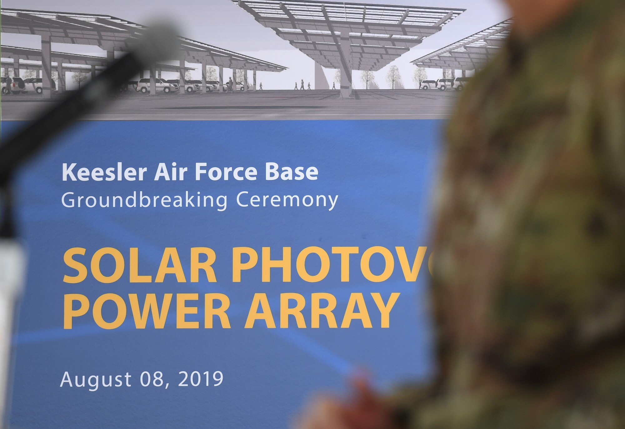 An artist's rendering of the new solar photovoltaic power array project is on display during a groundbreaking ceremony at the commissary parking lot on Keesler Air Force Base, Mississippi, Aug. 8, 2019. The ceremony introduced the project with NORESCO United Technologies, which will provide 497 solar panels on the exchange and commissary parking lot, generating over 2 million kilowatts annually as well as providing shade and shelter from inclement weather to the parked cars. It is scheduled for completion in May 2021. (U.S. Air Force photo by Kemberly Groue)