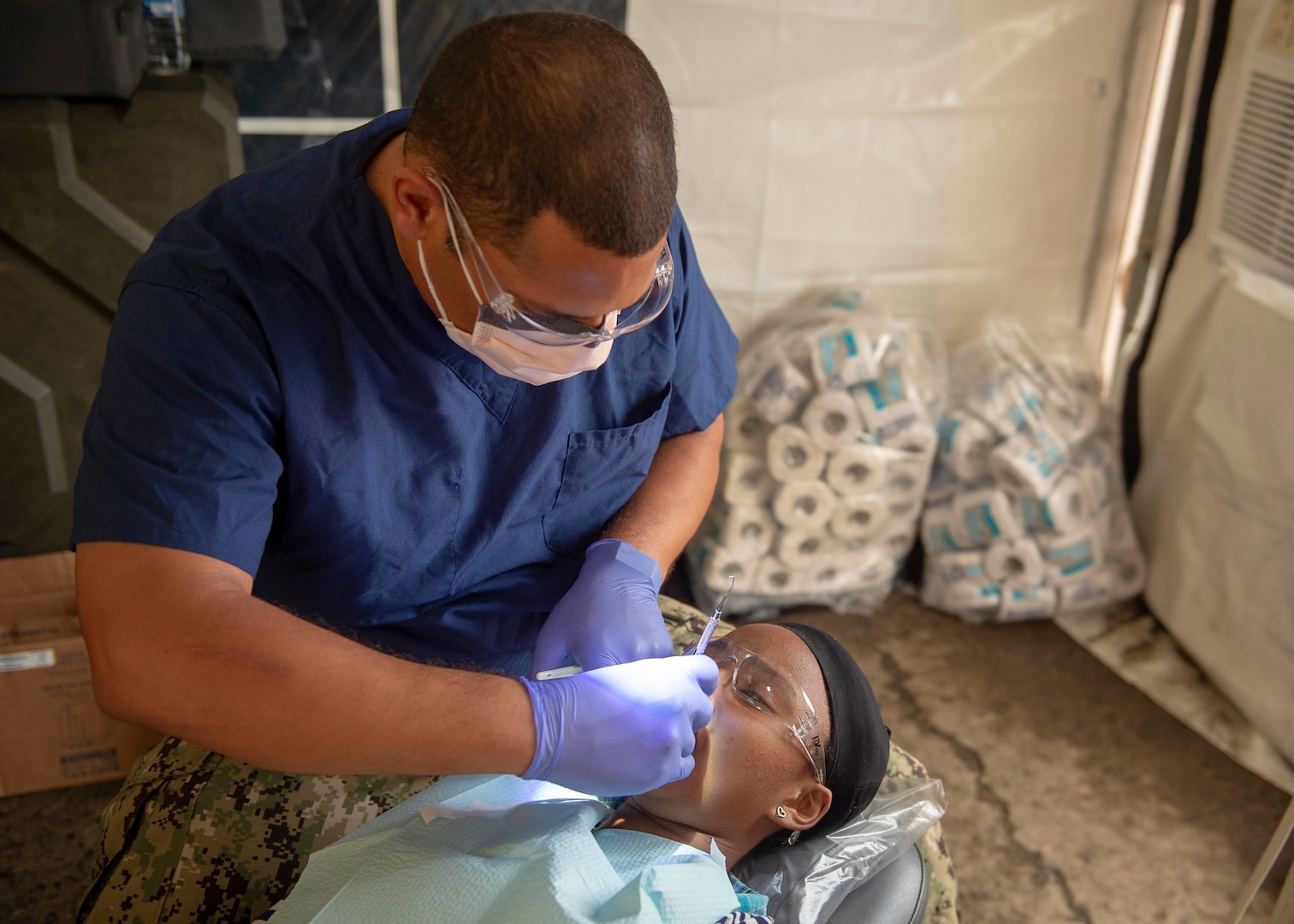 A dentist treats a patient.